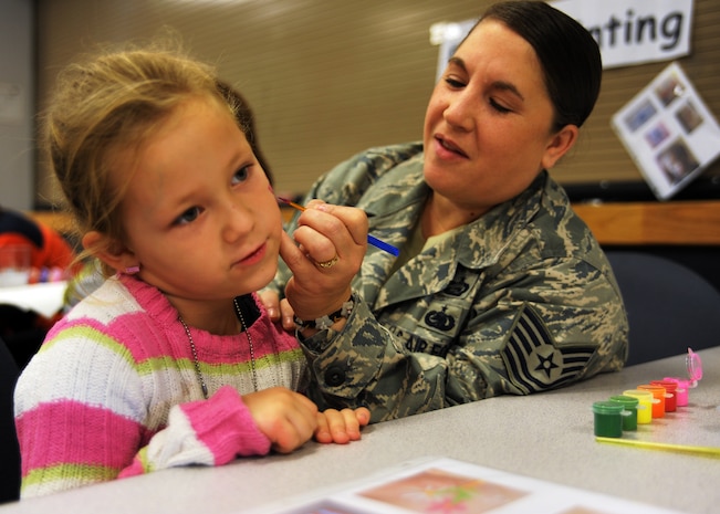 Cate Jones gets a butterfly painted on her face during the Children's Deployment Line Nov. 13, 2010, on Joint Base Charleston, S.C. The Children's Deployment Line is a program developed to help show children what their parents go through before they deploy downrange with a little bit of added fun. Cate is the 5-year-old daughter of Staff Sgt. Patti Jones. Sergeant Jones is the command chief executive assistant for the 437th Airlift Wing. (U.S. Air Force photo/Senior Airman Timothy Taylor)