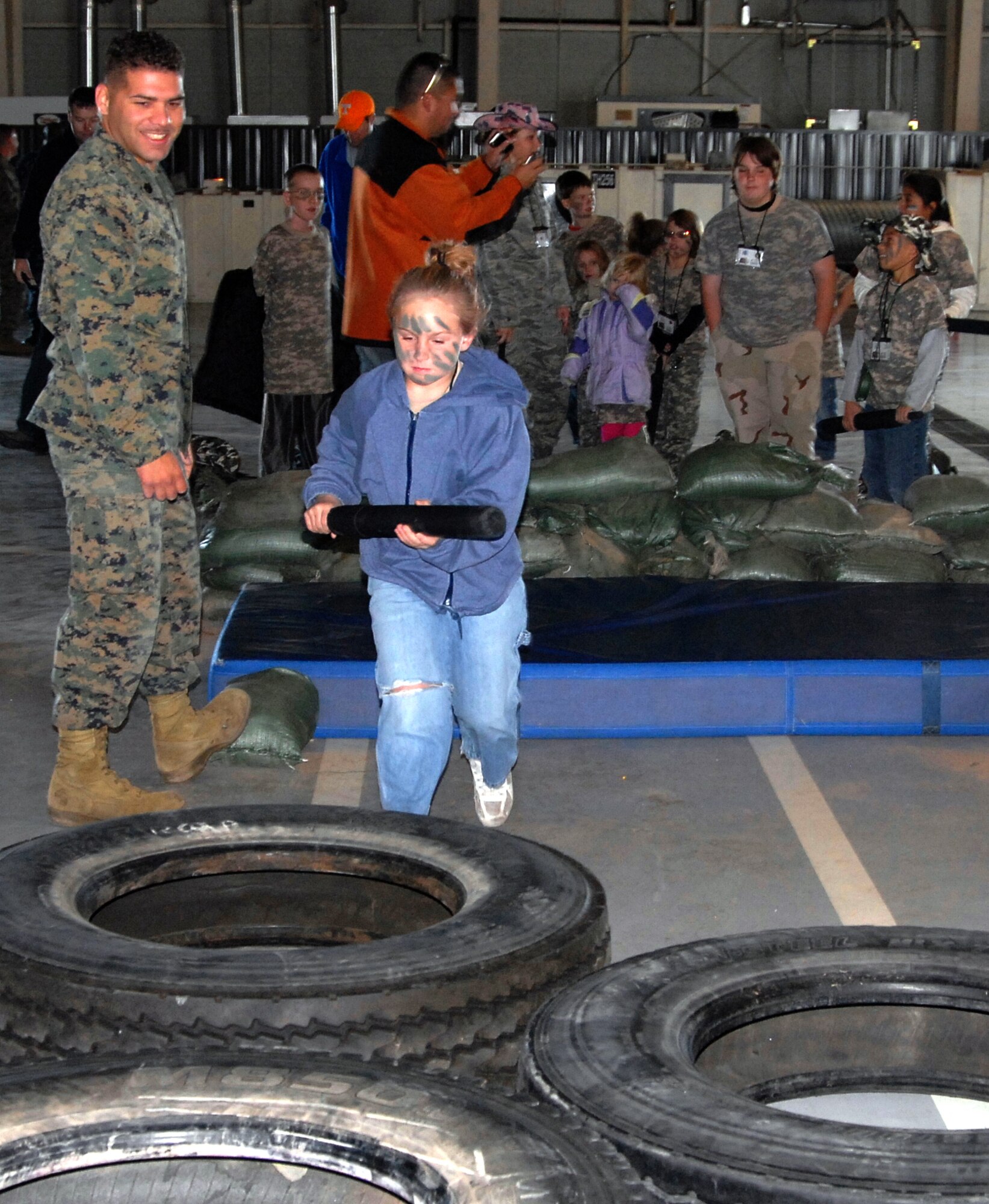 GOODFELLOW AIR FORCE BASE, Texas -- Alex Kelly, 8, makes her through the Marine Corps obstacle course at the deployed air base during Operation KIDS 2010 Nov. 13.  More than 60 military youths, ages 5-18, joined in this year's event to get a glimpse of what their military parent(s) go through when deploying.  (U.S. Air Force photo/Connie Hempel)