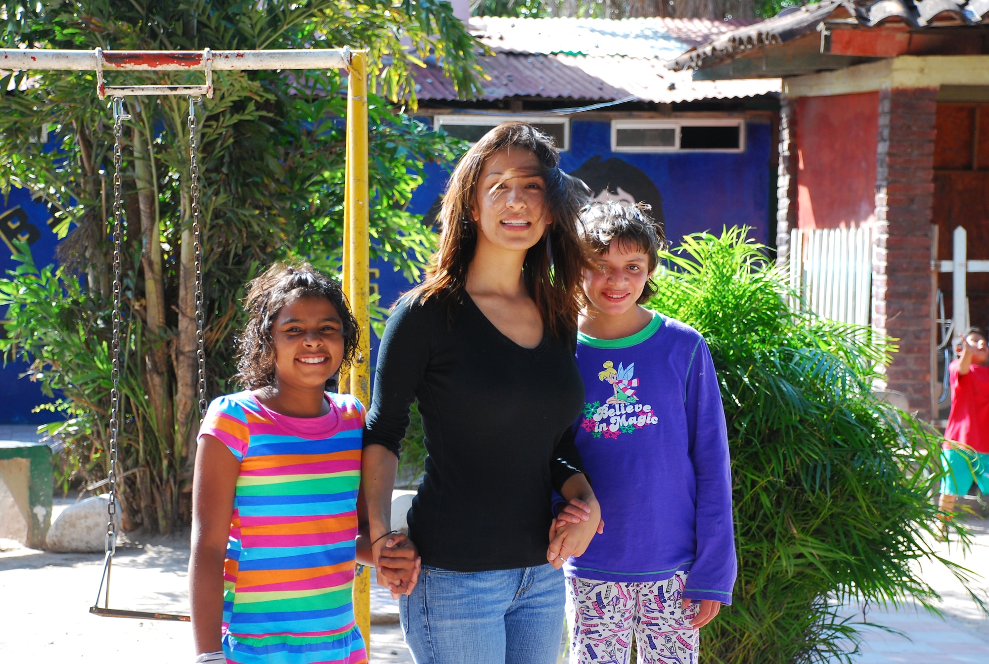 SOTO CANO AIR BASE, Honduras - U.S. Air Force Staff Sgt. Ana Najera with some friends from the Hogar Tierra Santa Orphanage, Sunday, 14 Nov 2010. 20 members of the Joint Task Force-Bravo team visited the children to serve them dinner, bring clothing and participate in games and laughter. orphanage is just one of several that are sponsored by members of JTF-B. (U.S. Air Force photo/Capt. John T. Stamm)