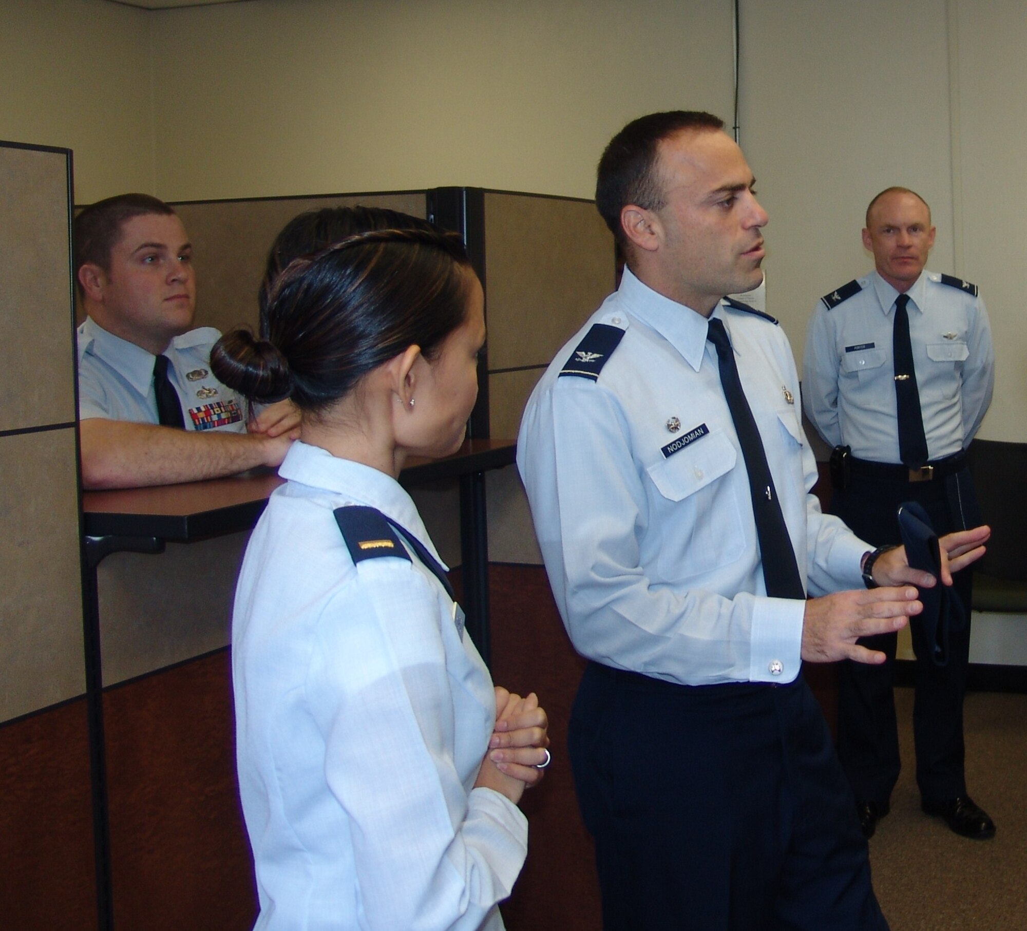 EGLIN AIR FORCE BASE, Fla. -- 2nd Lt. Lyka Santos, 96th Comptroller Squadron, briefs Col. Sal Nodjomian, 96th Air Base Wing commander, on the services available at the new CPTS customer service center.  The center is located at the front entrance of Bldg. 210. (USAF photo/Lois Walsh)