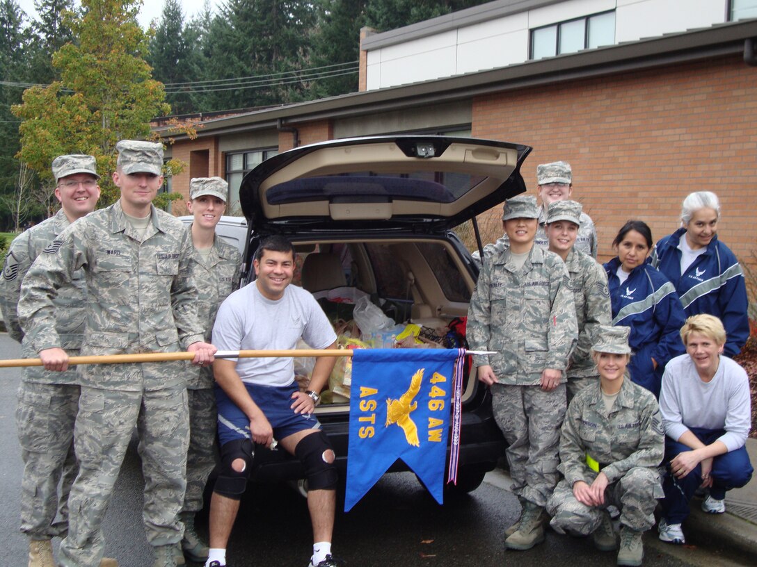 JOINT BASE LEWIS-MCCHORD, Wash., - The 446th Aeromedical Staging Squadron Reservists won the trophy in the 446th Airlift Wing's Care and Share food drive by collecting food and cash totaling $1,102.  The Care and Share program, managed by the 446th Mission Support Squadron's Airman and Family Readiness Flight, provides assistance to people in the 446th AW who are in need of a helping hand by providing food baskets for the holidays.  Picture in the back from left to right: Master Sgt. Ken Bielas, Tech. Sgts. James Ward, Fern Michael, Ed Tirado, Jennifer Weekly, and Courtney Lalla, Staff Sgt. Sarah Reynolds, and Tech. Sgts. Lenora Bruton and Vickie Andersen.  In the front, left to right: Master Sgts. Michelle Anderson and Pam Higgins. (Courtesy photo)
