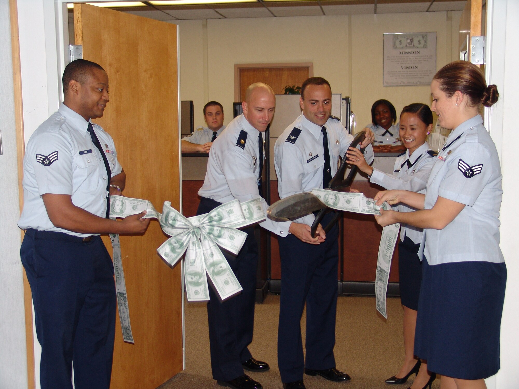 EGLIN AIR FORCE BASE, Fla. -- Col. Sal Nodjomian, 96th Air Base Wing commander and Maj. Bill Hunter, 96th Comptroller Squadron commander, cut the ribbon for the new CPTS customer service center.  The center is located at the front entrance of Bldg. 210. (USAF photo/Lois Walsh)