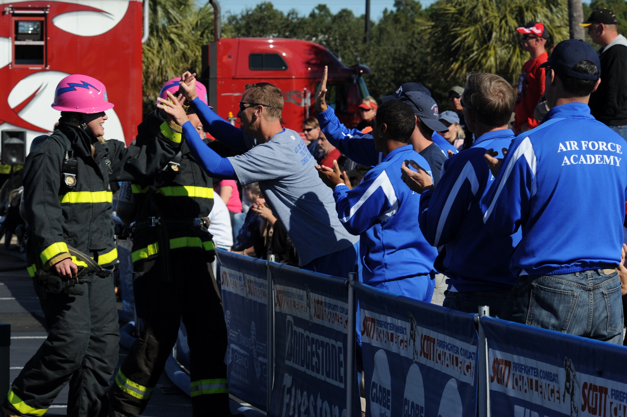 Senior Airman Jessica Morehouse and Stacy Billapando are congratulated by their Air Force Academy teammates after they completed the tandem event at the Scott Firefighter Combat Challenge in Myrtle Beach, S.C., on Nov. 13, 2010. Airman Morehouse is assigned to the Air Force Academy, Colorado Springs, Colo. (U.S. Air Force photo/Staff Sgt. Desiree N. Palacios)