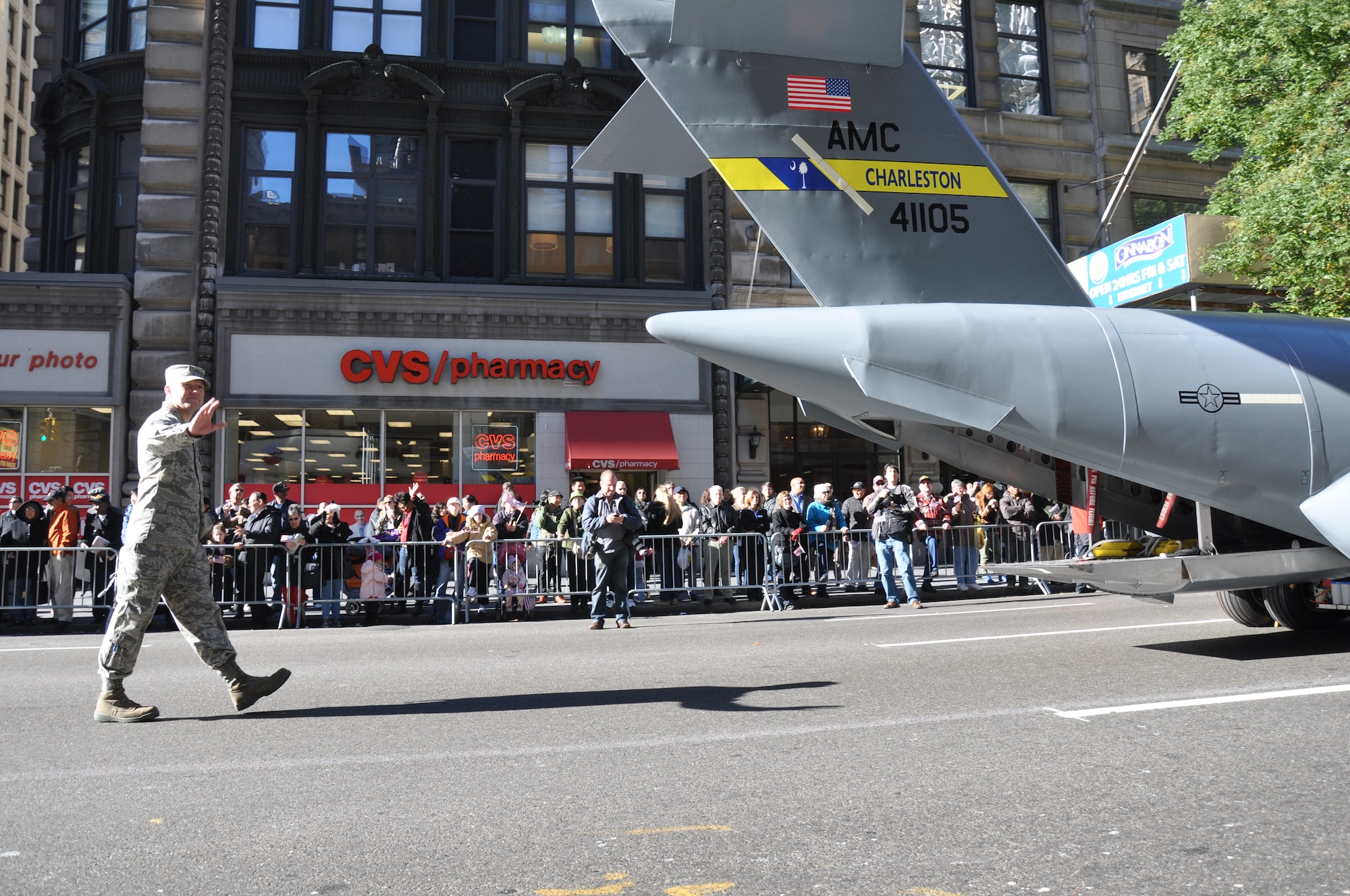 TSgt Alex Arntz, 315th AMXS waves to the crowd as he follows the mini C-17 replica up 5th Avenue during the New York City Veterans Day Parade Nov 12. TSgt Arntz and six other members of the 315th Airlift Wing represented Charleston AFB and the Air Force Reserve during the largest Veterans Day Parade in the country. (U.S. Air Force Photo/1Lt Joe Simms)