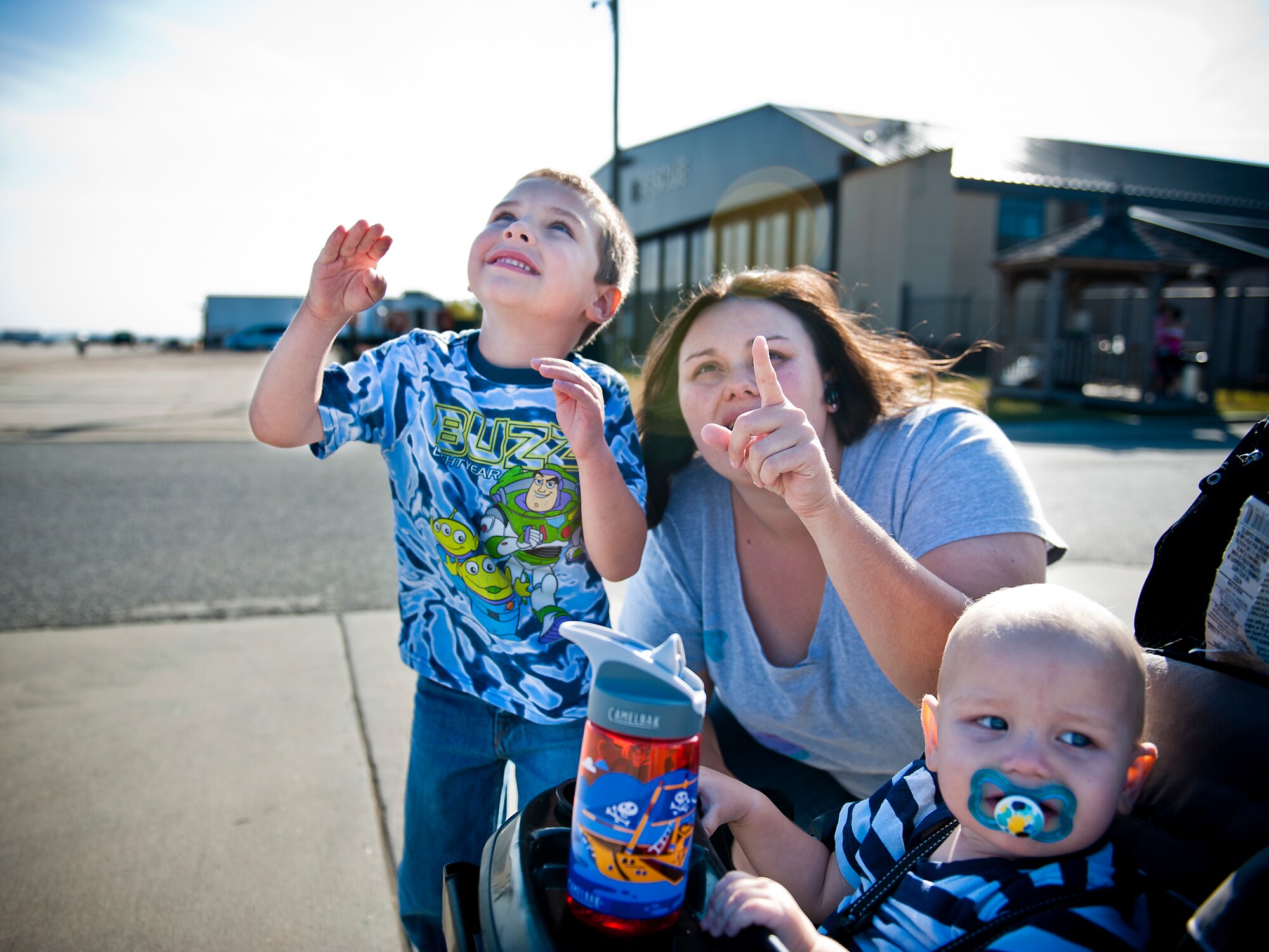 MOODY AIR FORCE BASE, Ga. -- Kristy Jansen and her sons, Lucas and Ethan (infant), observe an air demonstration during the Community Appreciation Day Air Show practice session Nov. 12. The practice session provided base families an opportunity to view demonstrations a day prior to the actual air show. Kristy, Lucas and Ethan are family members of Staff Sgt. Michael Jansen, 23rd Component Maintenance Squadron. "It's nice to be able to get a sneak peek of the air show without the crowds," said Mrs. Jansen. (U.S. Air Force photo/Senior Airman Jamal D. Sutter)(RELEASED)