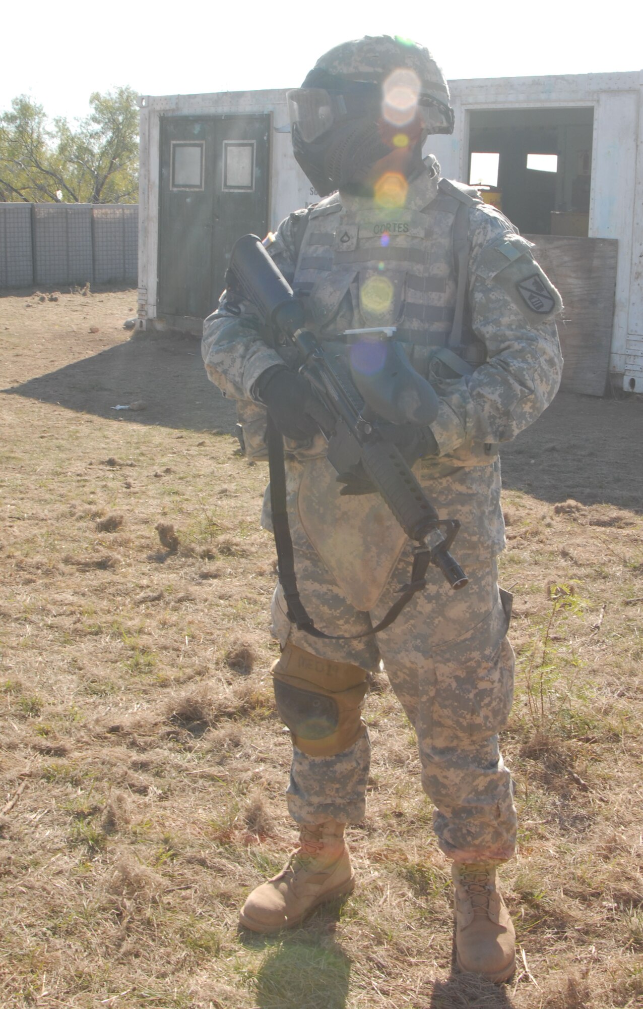 Army Private 1st Class Josue Cortes, 344th Military Intelligence Battation Bravo Company,secures a compound during a field training exercise at the Afghan Village here Oct. 10.  The two-week exercise simulates life in a deployed environment and prepares students for life down range. (U.S. Air Force photo/Airman 1st Class Jessica D. Keith)