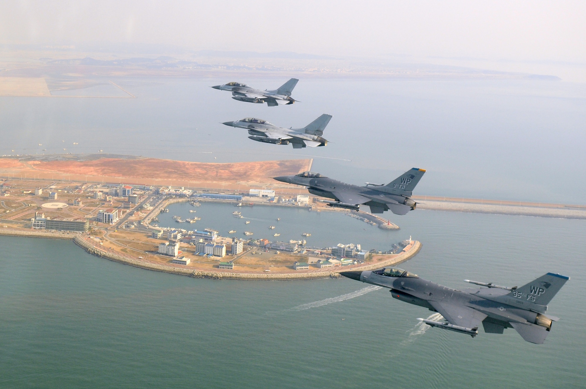 Four F-16 Fighting Falcons fly during a U.S. and South Korean air force coalition flight Nov. 10, 2010, over the Piung Harbor, South Korea. The flight was in celebration of the 60th anniversary of the Korean War. (U.S. Air Force photo/Master Sgt. Jason Wilkerson)