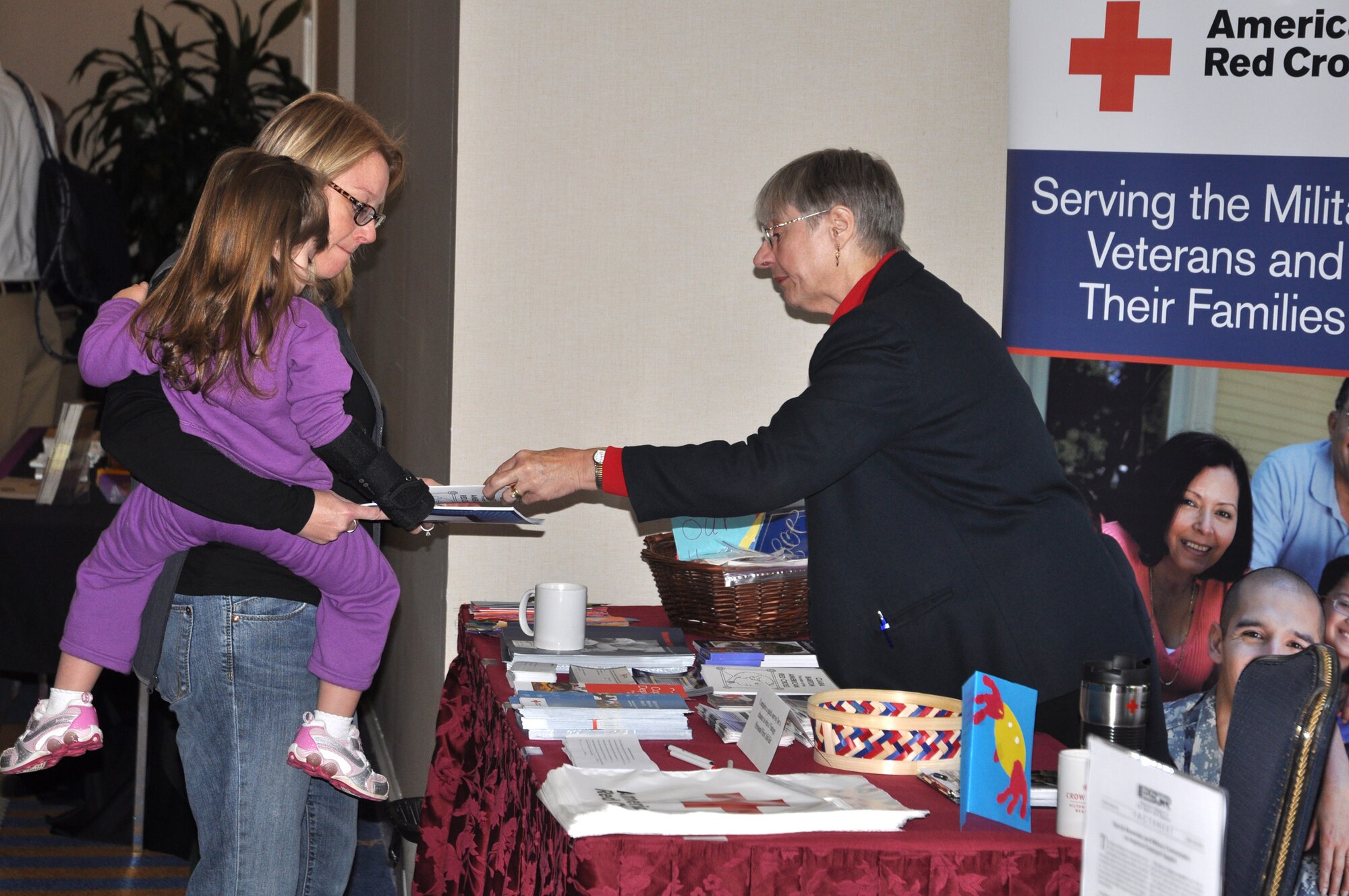 Eileen Hadbavny, the Service to Armed Forces and International Services Chair for the American Red Cross, Carolina Lowcountry Chapter provides information to families about benenfits and services provided by the Red Cross at the Yellow Ribbon Program event Nov. 12-14, 2010 at Hilton Head, S.C.  (U.S. Air Force photo/Airman 1st Class Robert Pilch)