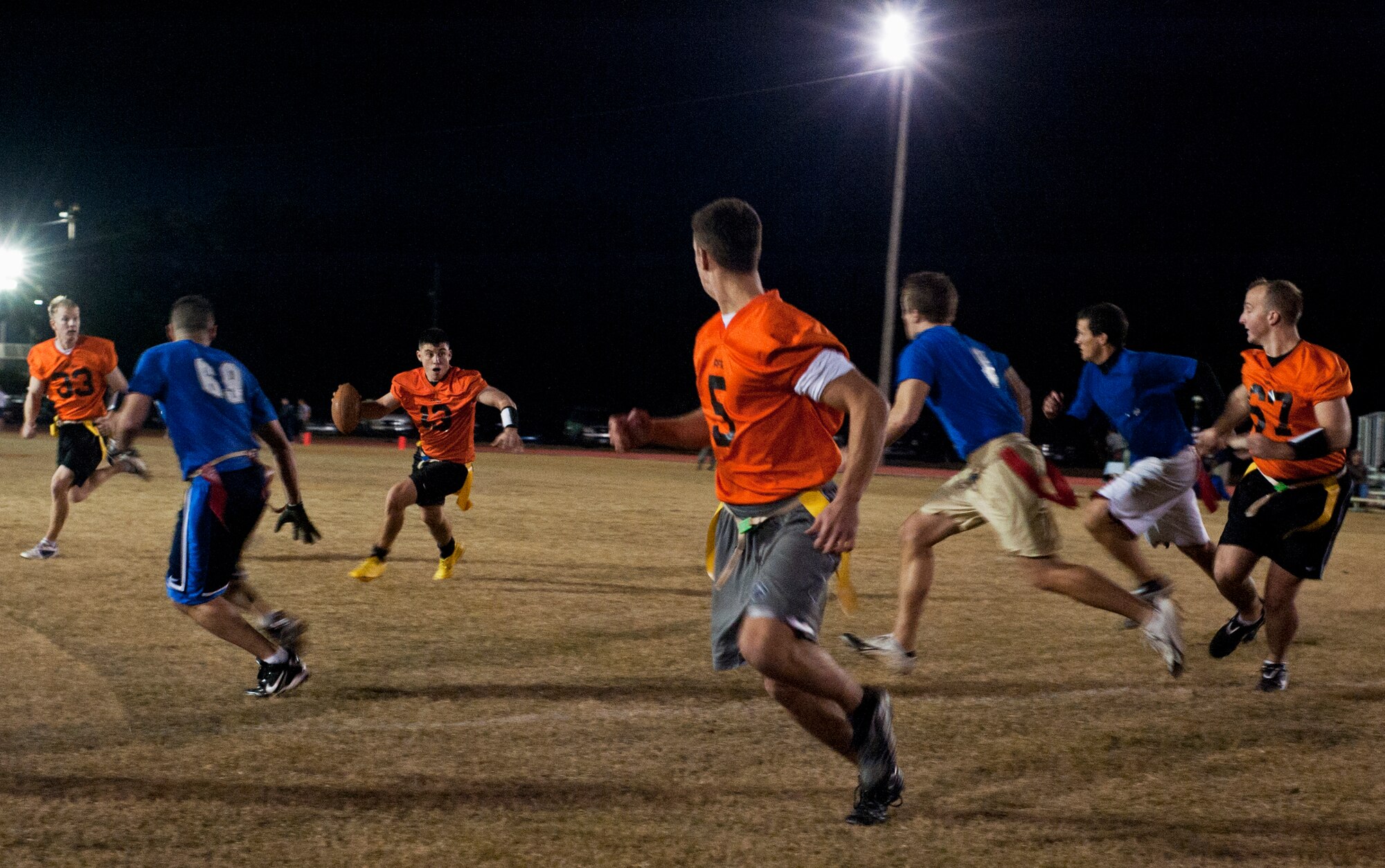 Air Force Research Lab’s Chris Hergenreter looks for the open man down field during his team’s championship winning-drive at the end of the base intramural playoffs, Nov. 10.  AFRL defeated the 53rd (14-12) in the second of two games to win back-to-back base titles.  The 53rd team gave AFRL its only loss of the season, (20-19) earlier in the evening, forcing a winner-take-all game in the double-elimination tournament.  (U.S. Air Force photo/ Samuel King Jr.)