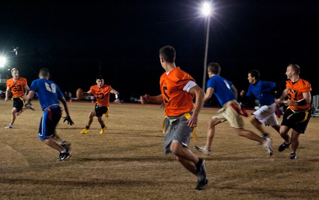 Air Force Research Lab’s Chris Hergenreter looks for the open man down field during his team’s championship winning-drive at the end of the base intramural playoffs, Nov. 10.  AFRL defeated the 53rd (14-12) in the second of two games to win back-to-back base titles.  The 53rd team gave AFRL its only loss of the season, (20-19) earlier in the evening, forcing a winner-take-all game in the double-elimination tournament.  (U.S. Air Force photo/ Samuel King Jr.)