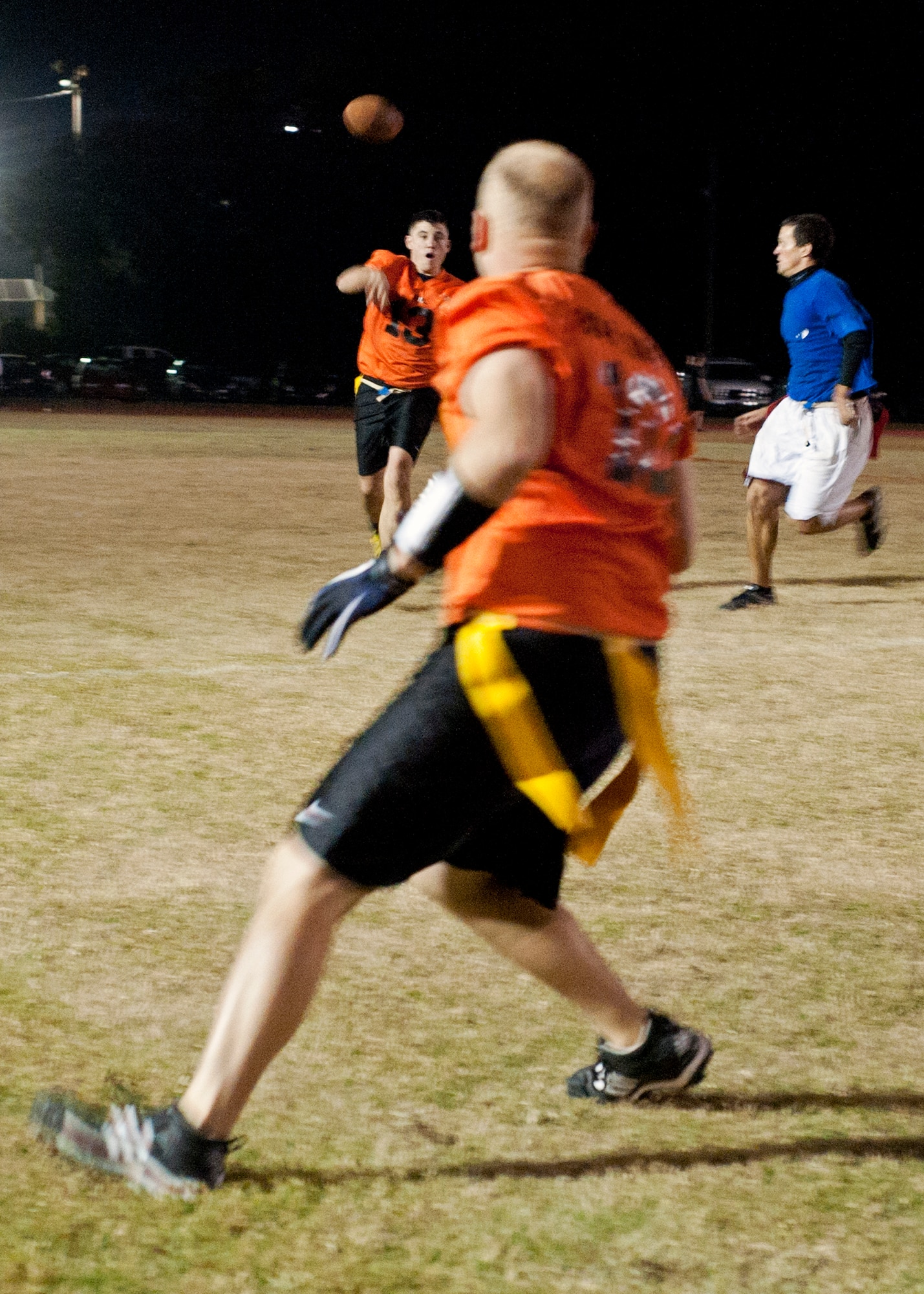Air Force Research Lab’s Chris Hergenreter, tosses a pass to Jon Bowling, during the championship winning-drive at the end of the base intramural playoffs, Nov. 11.  AFRL defeated the 53rd (14-12) in the second of two games to win back-to-back base titles.  The 53rd team gave AFRL its only loss of the season, (20-19) earlier in the evening, forcing a winner-take-all game in the double-elimination tournament.  (U.S. Air Force photo/ Samuel King Jr.)