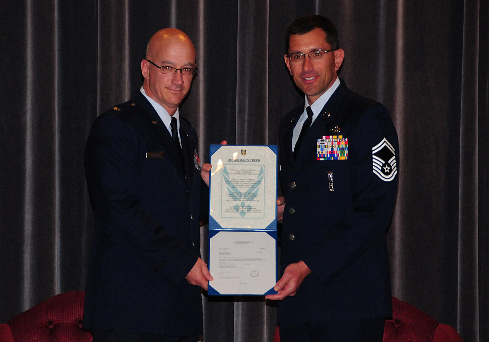 Being promoted to Chief Master Sgt. James M. Nudd (right), is sworn in by Lt. Col. Barry Cupples (left) 914th Airlift Wing presiding officer November 12, 2010, Niagara Falls Air Reserve Station, NY. Among those in attendance at Nudd’s promotion where family, friends, New York State Senator George Maziarz and New York Assemblyman Steve Hawley. (U.S. Air Force photo by Mr. Peter Borys)