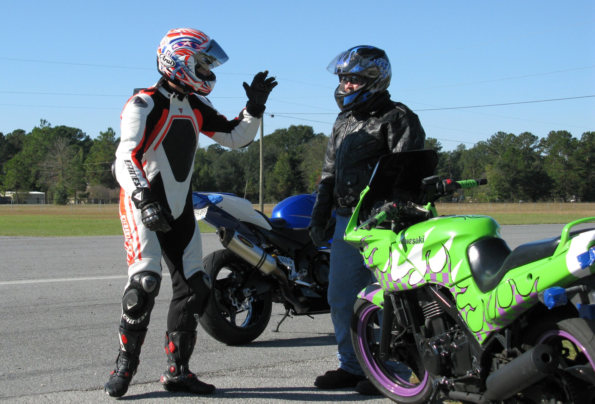 Lt. Col. Scott Freeland offers safety tips to Tech. Sgt. Jeffrey Bare at Roebling Road Track in Bloomingdale, Ga., Nov. 8, 2010, during the Air Force Reserve Command motorcycle safety stand down day. Headquarters Air Force Reserve Command Safety offered the free one-day course to help military motorcycle riders practice skills that will help them negotiate hazards on the road. (U.S. Air Force photo/Master Sgt. Rachael Cox)