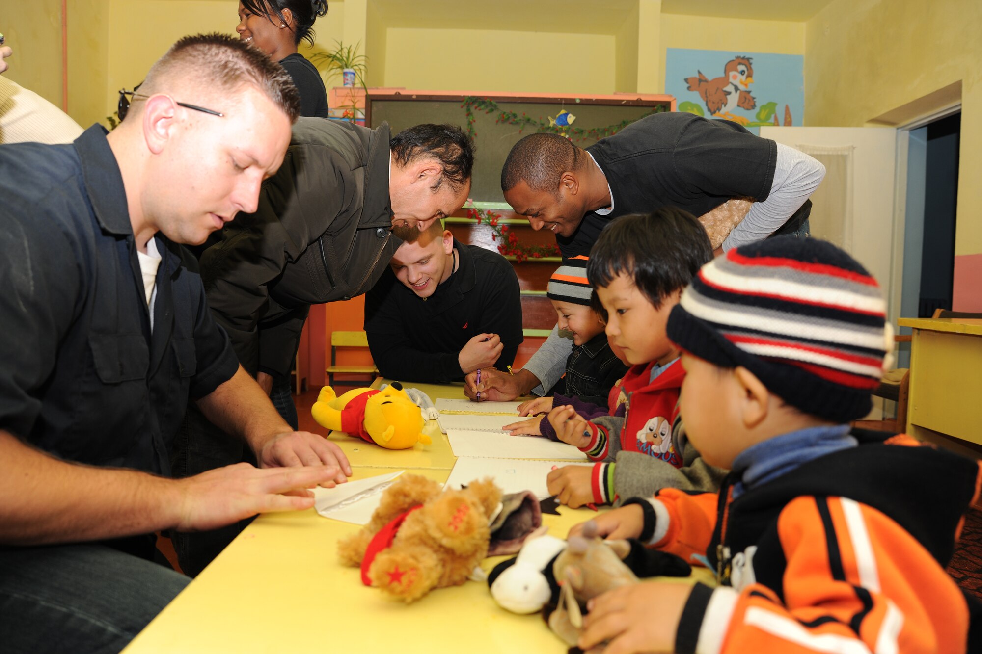 GRODZ VILLAGE, Kyrgyzstan - Airmen from the Transit Center at Manas gave students stuffed animals and colored with them during their visit Nov. 12. They delivered five tons of coal and will have another five tons delivered in a few months to help keep the school warm. Last year, Grodz Kindergarten was closed for the winter. (U.S. Air Force Photo/Staff Sgt. Nathan Bevier)
