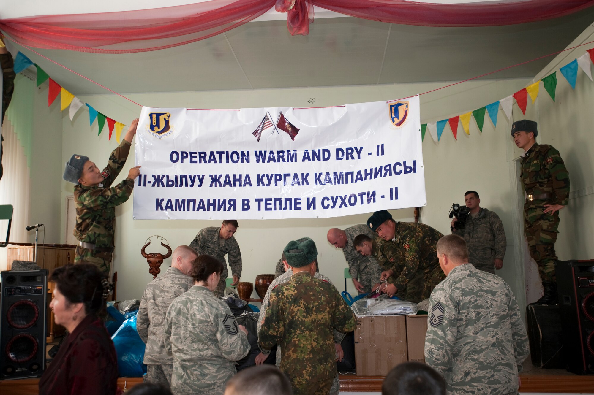 KOI-TASH, Kyrgyzstan - U.S. and Kygyz service members prepare to hand out coats to students at the Chuiskaya Region Boarding School-Gymnasium Nov. 11 as part of Operation Warm and Dry II. (U.S. Air Force Photo/Tech. Sgt. Jennifer Buzanowski)