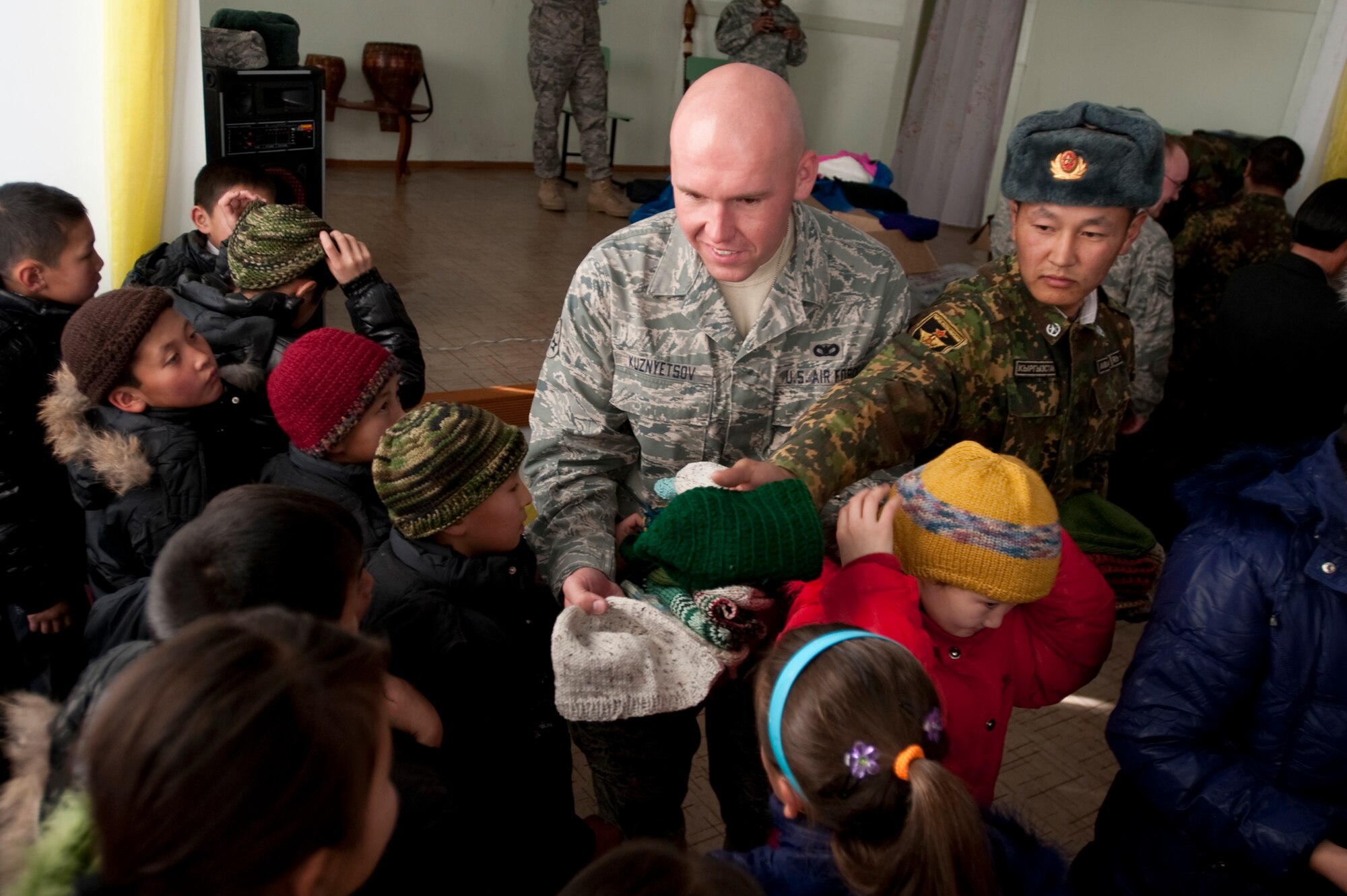KOI-TASH, Kyrgyzstan - The Kyrgyz and U.S. service members gave Chuiskaya Region Boarding School-Gymnasium  students warm coats and hats as part of Operation Warm and Dry II Nov. 11. (U.S. Air Force Photo/Tech. Sgt. Jennifer Buzanowski)