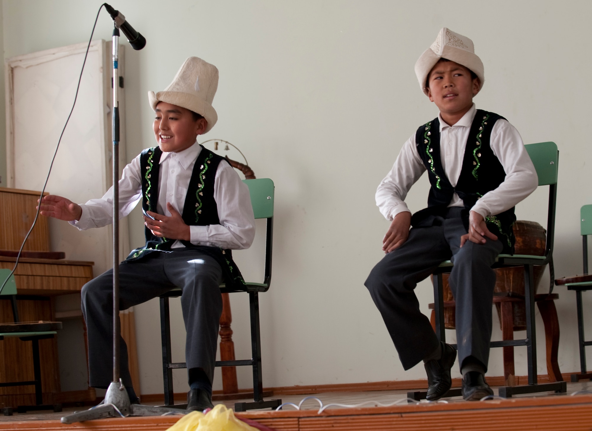 KOI-TASH, Kyrgyzstan - Two boys perform Manas impressions as part of a cultural concert by the Chuiskaya Region Boarding School-Gymnasium Nov. 11 for Kyrgyz and U.S. service members. The two militaries gave students warm coats and hats as part of Operation Warm and Dry II. (U.S. Air Force Photo/Tech. Sgt. Jennifer Buzanowski)