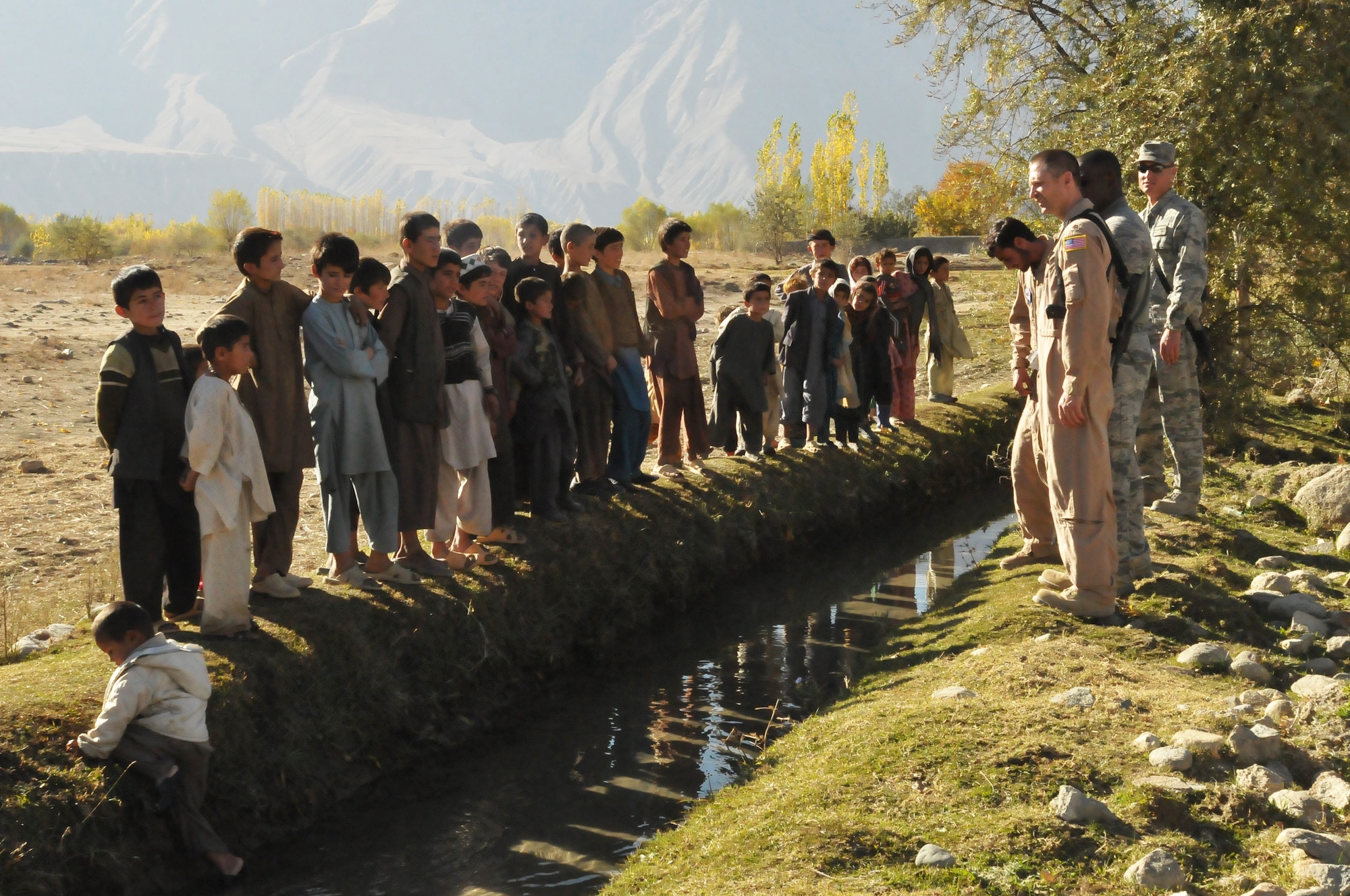 BAHARAK, Afghanistan --Airmen from the 438th Air Expeditionary Wing greet children during a humanitarian assistance mission in the town of Baharak in Badakhshan province. The airmen, along with Afghan Air Force and coalition forces, visited the area to support operations aimed at building an orphanage in the area. (US Navy photo by MC2 Vladimir V. Potapenko/RELEASED)



