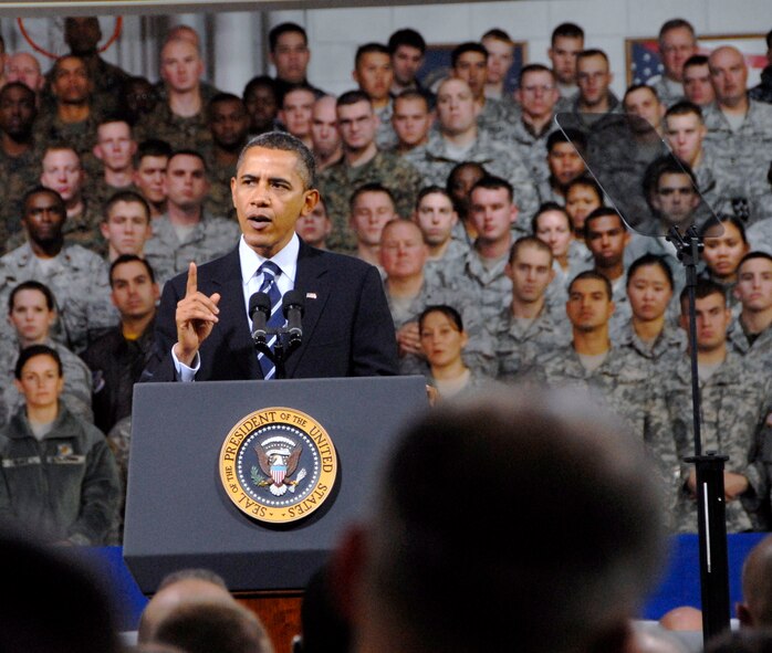US ARMY GARRISON YONGSAN, Republic of Korea -- Members of the 8th Fighter Wing sit amongst other U.S. military members in the bleachers behind President Barack Obama as he speaks at U.S. Army Garrison Yongsan, Republic of Korea, Nov. 11. More than 50 Wolf Pack Airmen traveled to Yongsan to hear the President's Veterans Day speech. (U.S. Air Force photo/Staff Sgt. Amanda Savannah)