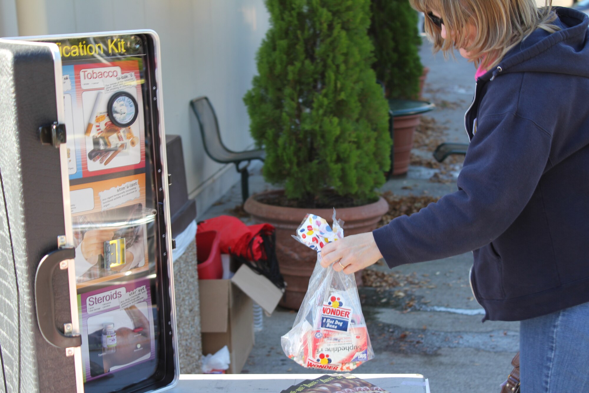 YOKOTA AIR BASE, Japan -- A base resident drops off unwanted medications at the East Shoppette during the medication drop-off event here, Nov. 10. The event kicked off the Lock Your Meds campaign, sponsored by the Drug Demand Reduction Program. The campaign aims to encourage people to safeguard medications and properly discard any that are no longer needed. (U.S. Air Force photo submission/Sequoiya Lawson)