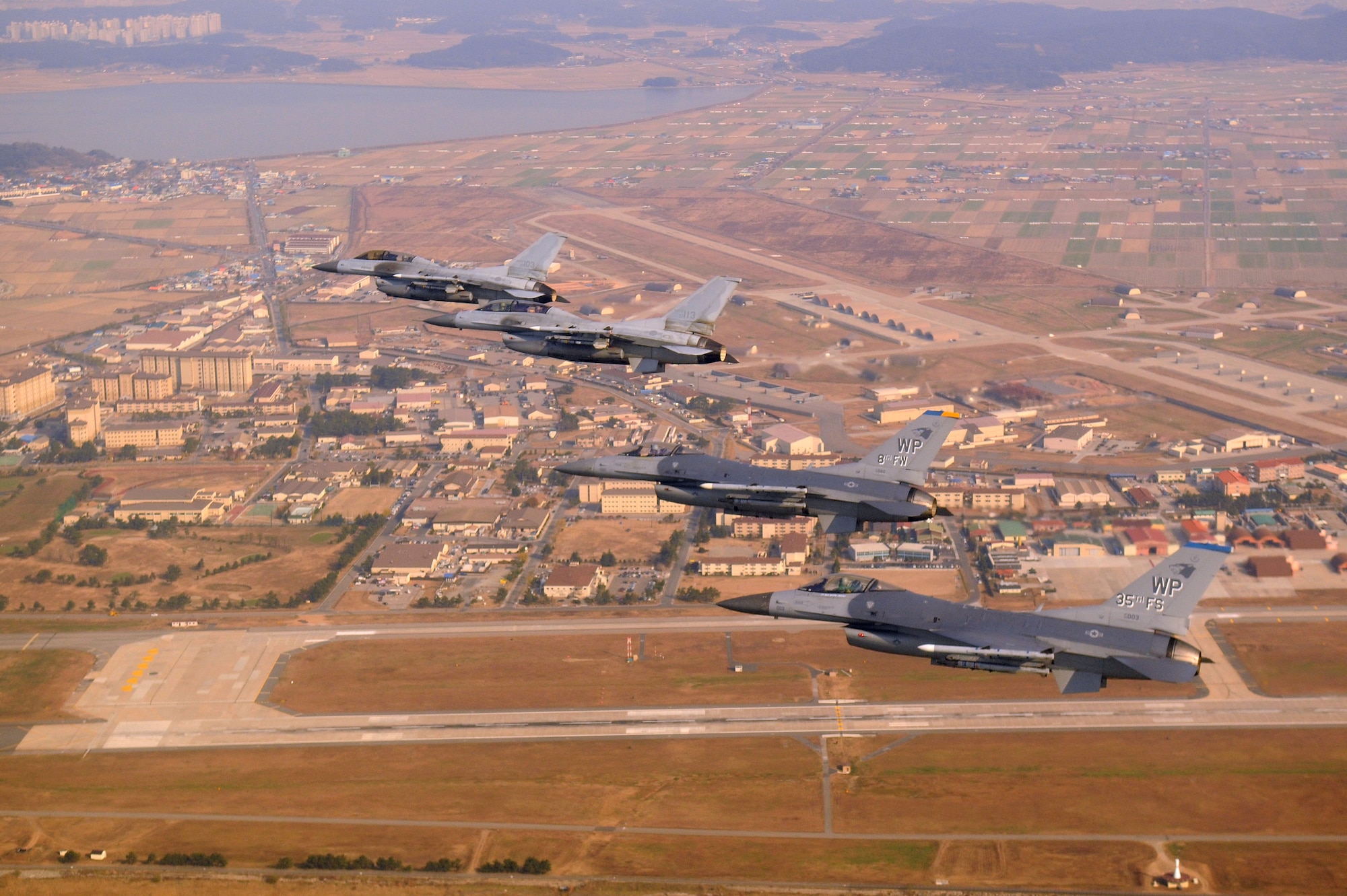 KUNSAN AIR BASE, Republic of Korea -- Four F-16 Fighting Falcons fly over Kunsan AB during a U.S. and Republic of Korea Air Force Coalition flight Nov. 10 in celebration of the 60th anniversary of the Korean War. (U.S. Air Force photo/Master Sgt. Jason Wilkerson)