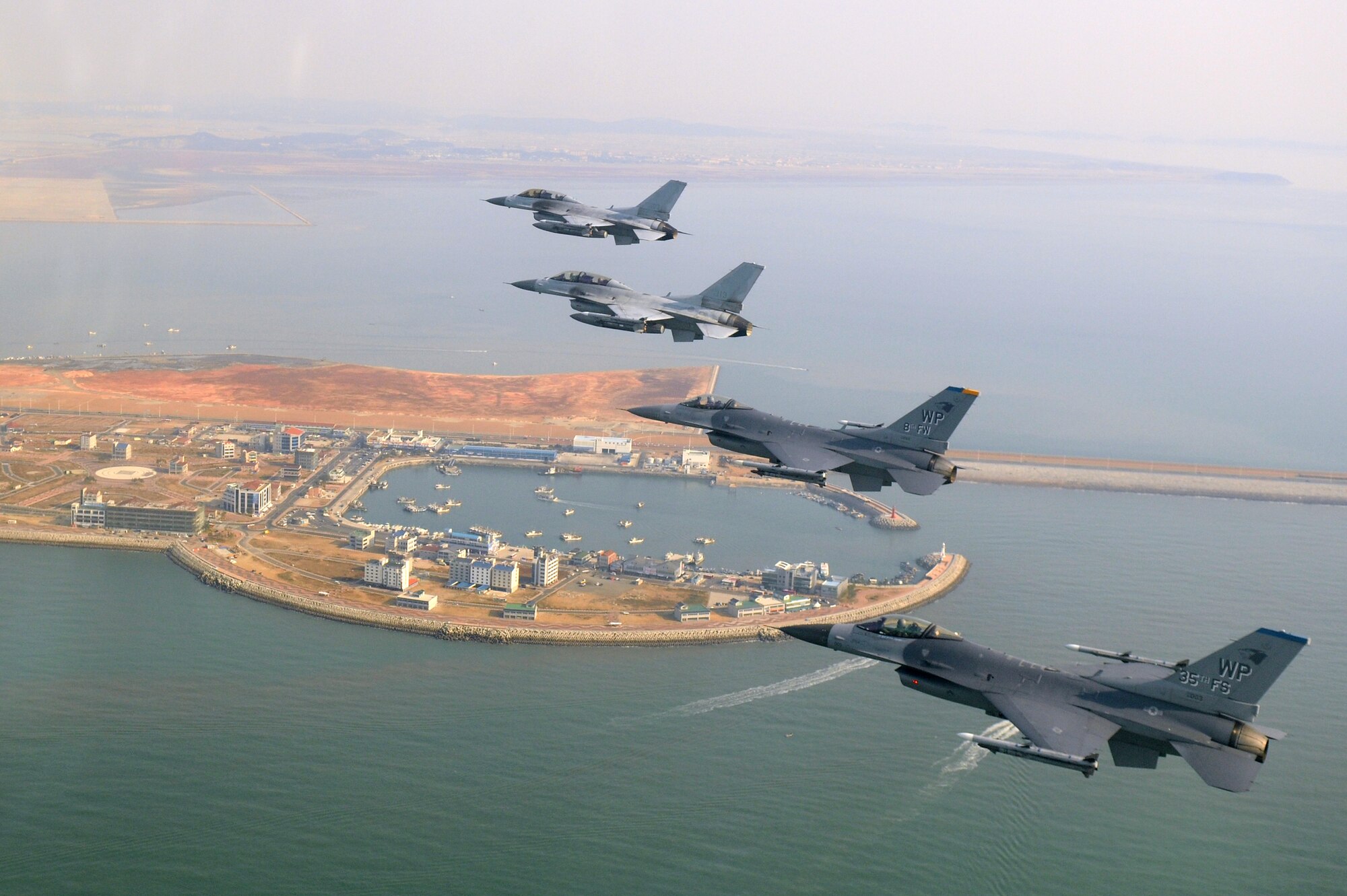 KUNSAN AIR BASE, Republic of Korea -- Four F-16 Fighting Falcons fly over the Piung Harbor during a U.S. and Republic of Korea Air Force Coalition flight Nov. 10 in celebration of the 60th anniversary of the Korean War. (U.S. Air Force photo/Master Sgt. Jason Wilkerson)