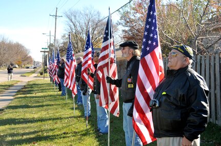 Members of the Patriot Guard Riders stand at attention during a street re-naming ceremony held Nov 15 in honor of 1st Lieutenant Mark Noziska, who was killed Aug 30, 2010 by a roadside bomb while serving in Afghanistan. Four blocks of Polk Street in Papillion, Neb., were re-named in memory of Lt Noziska, who served as a platoon leader in the 22nd Infantry Regiment, U.S. Army. Lt Noziska lived on Polk St during his high school years.
