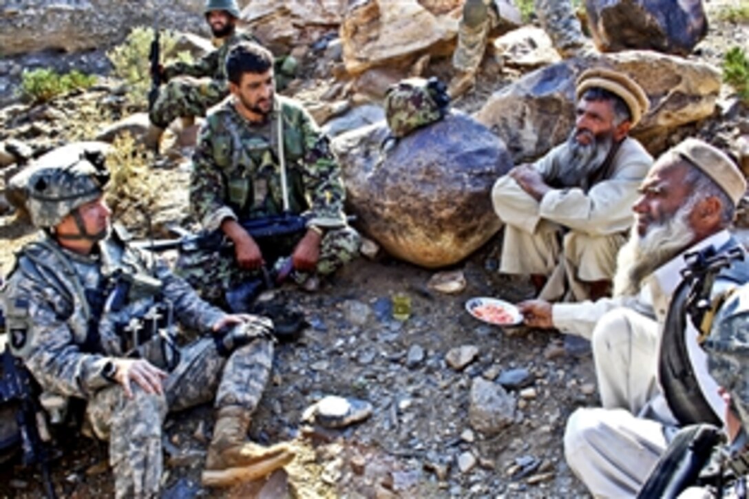 U.S. Army 2nd Lt. Daniel Wild, left, and an Afghan army weapons team leader, second from left, talk with Gurem village elders in Nangarhar province, Afghanistan, Nov. 6, 2010. Wild is assigned to 1st Squadron, 61st Cavalry Regiment.