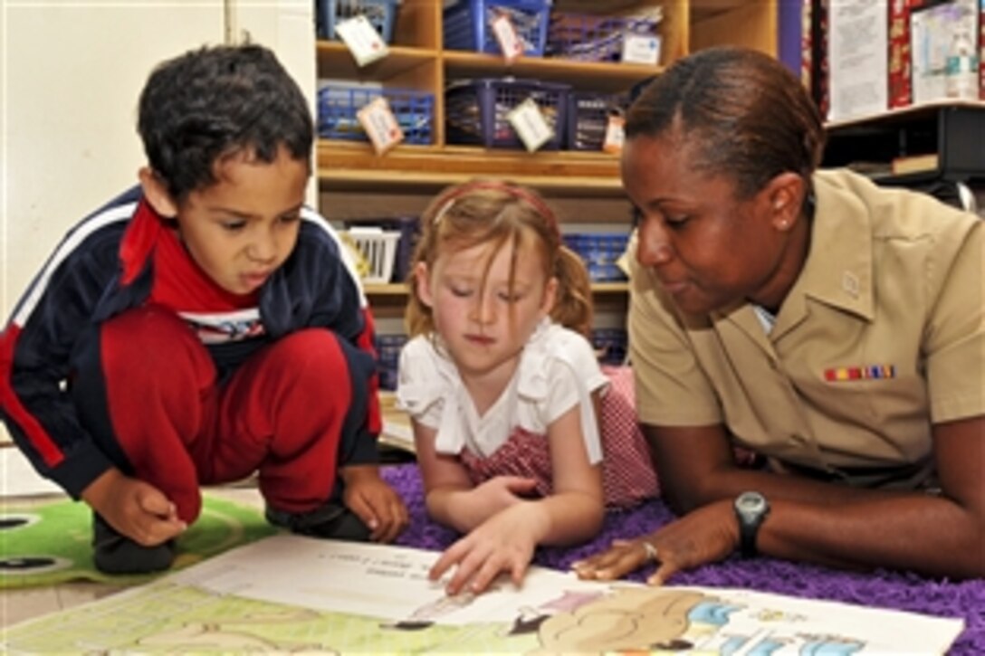 U.S. Air Force Airman Tamara Mitchell reads with kindergartners from San Pablo Elementary School in Jacksonville, Fla., Nov. 9, 2010. Mitchell is an aviation structural mechanic assigned to Helicopter Maritime Strike Squadron 40, which has an ongoing partnership with the school and participates in more than 30 events throughout the year.