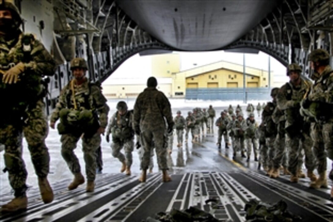 U.S. and Indian soldiers load up into the back of a C-17 aircraft to prepare for a combined parachute jump over Joint Base Elmendorf-Richardson, Alaska, Nov. 10, 2010.