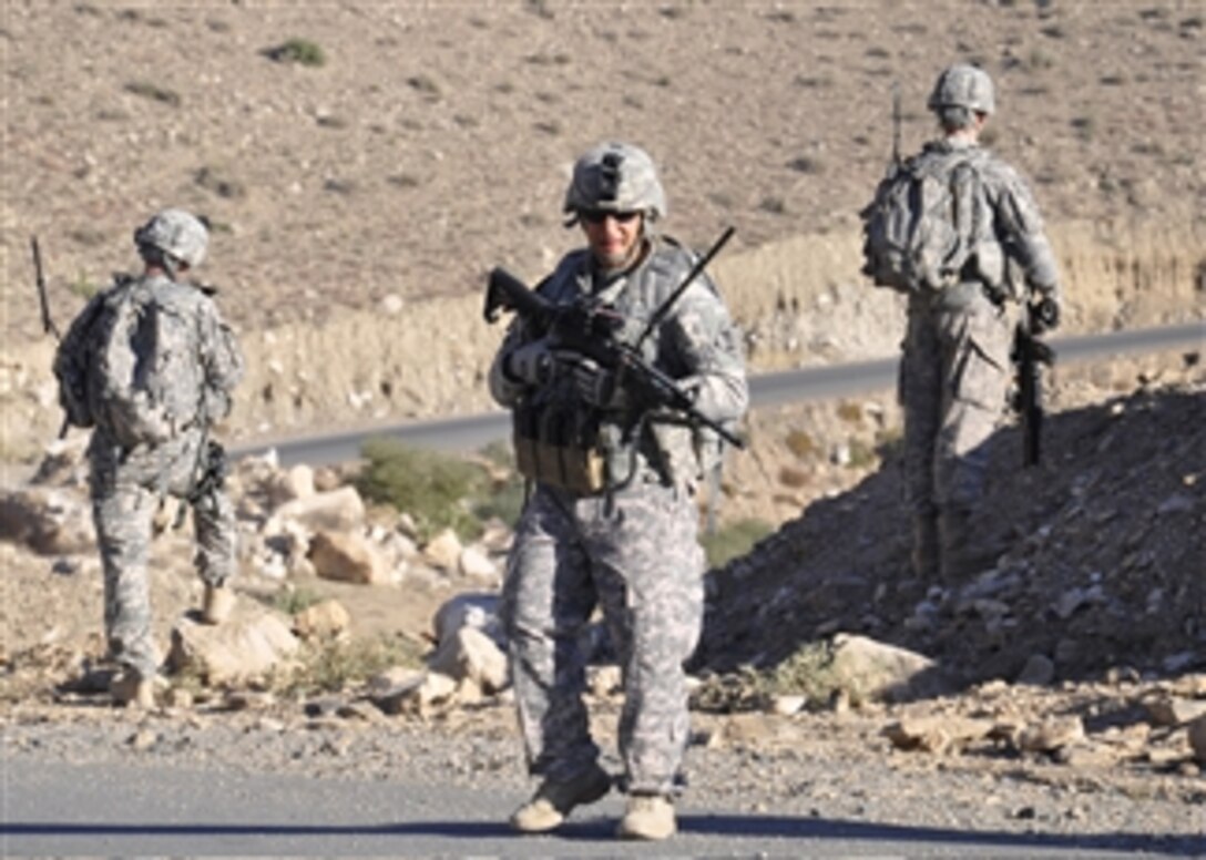 U.S. Army Sgt. Keith Radcliffe (2nd from right), a security force member with the Nuristan Provincial Reconstruction Team, conducts a dismounted patrol through the town of Nengarash in Nuristan province, Afghanistan, on Nov. 11, 2010.  Provincial Reconstruction Teams work with the government of Afghanistan to improve security for Afghan citizens as well as to ensure the areas around forward operating bases are secure.  