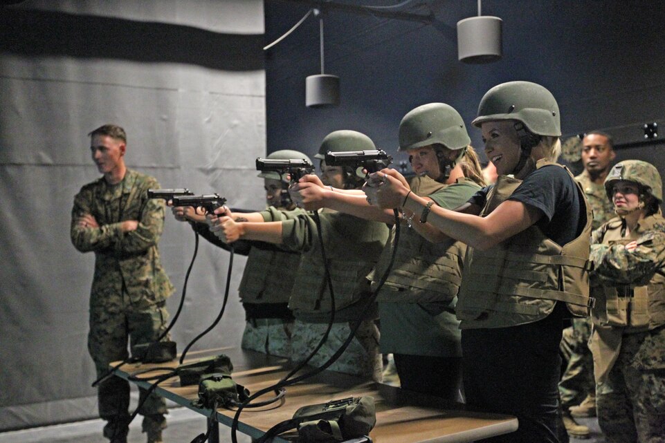 Wives with 2nd Battalion, 7th Marine Regiment’s Jane Wayne Day fire off rounds at the Indoor Simulated Marksmanship Trainer during their trip there Wednesday. The day is meant to build camaraderie amongst spouses within the battalion. ::r::::n::