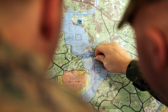 Sgt. Brandon Craven, a motor transportation operator with Combat Logistics Battalion 6, 2nd Marine Logistics Group, who is head of the Command Operations Center, plots a coordinate on a map during a COC exercise aboard Camp Lejeune, N.C., Nov. 17, 2010. The exercise was held in order for Marines to learn basic skills such as plotting points and reading grids on maps, and sending and receiving calls through the radio. (U.S. Marine Corps photo by Pfc. Franklin E. Mercado)