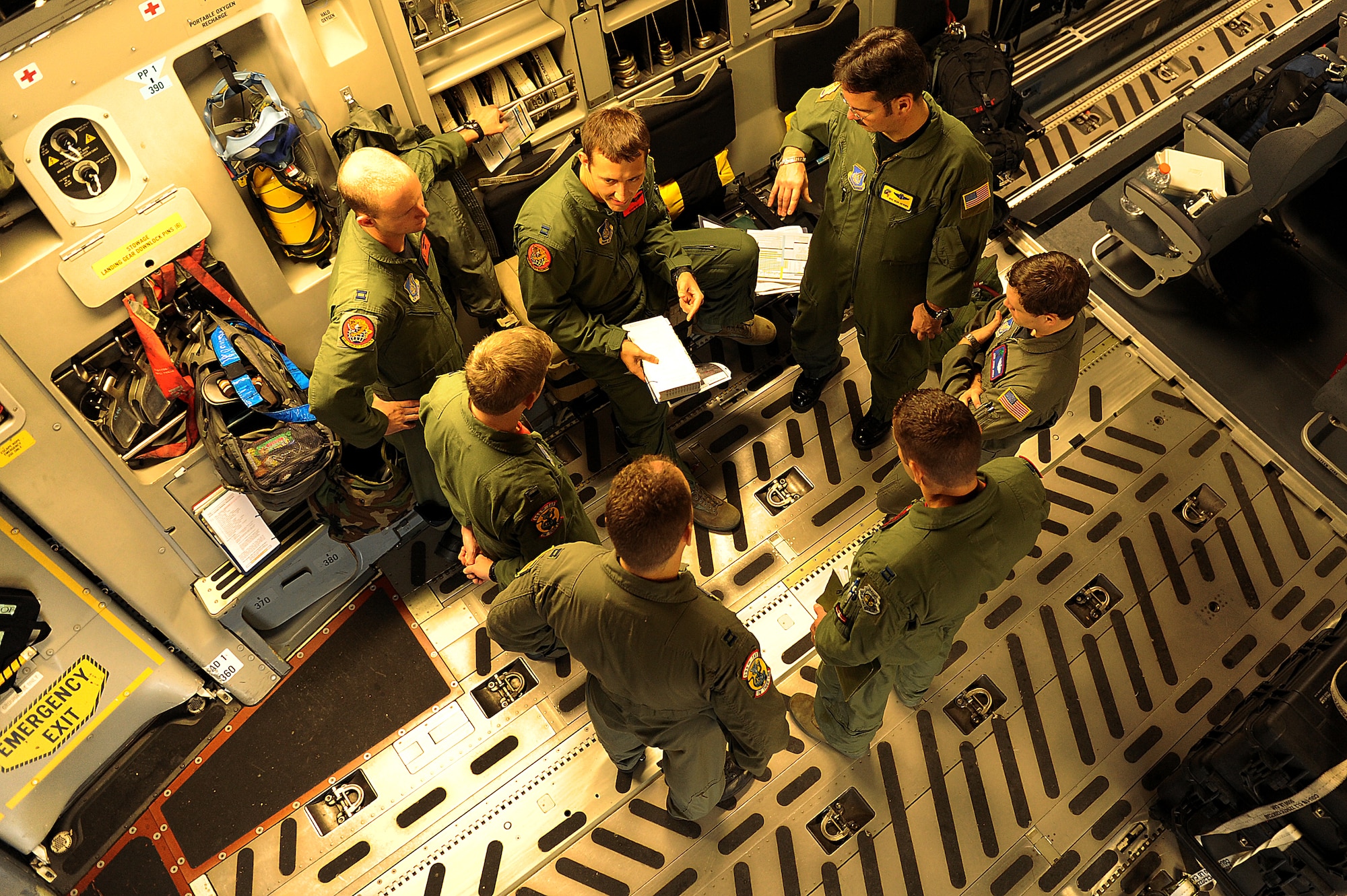 A 535th Airlift Squadron C-17 aircrew go through a final crew briefing prior to take-off for an airdrop mission Nov. 12.The 535th AS aircrew trained in unrestricted descent assault landings, air drop, combat offloads, air refueling, night vision goggle training, combat offloads, low levels, mountainous terrain, assault landings, threat responses and multiple ship formation training during a five day training trip to Washington Nov 12-17. (U.S. Air Force photo/Staff Sgt. Mike Meares)