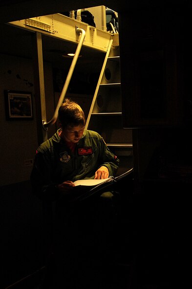 1st Lt. Kevin Vandergriff, 535th Airlift Squadron C-17 pilot, reviews maintenance forms prior to takeoff Nov. 12. The 535th AS aircrew trained in unrestricted descent assault landings, air drop, combat offloads, air refueling, night vision goggle training, combat offloads, low levels, mountainous terrain, assault landings, threat responses and multiple ship formation training during a five day training trip to Washington Nov 12-17. (U.S. Air Force photo/Staff Sgt. Mike Meares)