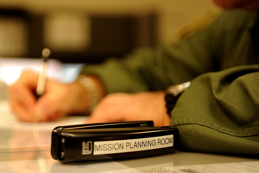 Master Sgt. Brian Chewning, 15th Operations Group standardization and evaluation loadmaster, is filling out a time tracker sheet prior to a multi-day mission to Joint Base Lewis-McChord. The 535th Airlift Squadron aircrew trained in unrestricted descent assault landings, air drop, combat offloads, air refueling, night vision goggle training, combat offloads, low levels, mountainous terrain, assault landings, threat responses and multiple ship formation training during a five day training trip to Washington Nov 12-17. (U.S. Air Force photo/Staff Sgt. Mike Meares)