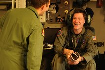 Capt. Nathan Padgett and Staff Sgt. Jason Jones, 535th Airlift Squadron, has a moment of levity prior to a training mission Nov. 13 at Joint Base Lewis-McChord. The 535th AS aircrew trained in unrestricted descent assault landings, air drop, combat offloads, air refueling, night vision goggle training, combat offloads, low levels, mountainous terrain, assault landings, threat responses and multiple ship formation training during a five day training trip to Washington Nov 12-17. (U.S. Air Force photo/Staff Sgt. Mike Meares)