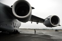 Staff Sgt. Robert Wolf, 15th Maintenance Squadron C-17 crew chief, conducts post flight maintenance inspection after a training mission Nov. 13 at Joint Base Lewis-McChord. The 535th Airlift Squadron aircrew trained in unrestricted descent assault landings, air drop, combat offloads, air refueling, night vision goggle training, combat offloads, low levels, mountainous terrain, assault landings, threat responses and multiple ship formation training during a five day training trip to Washington Nov 12-17. (U.S. Air Force photo/Staff Sgt. Mike Meares)