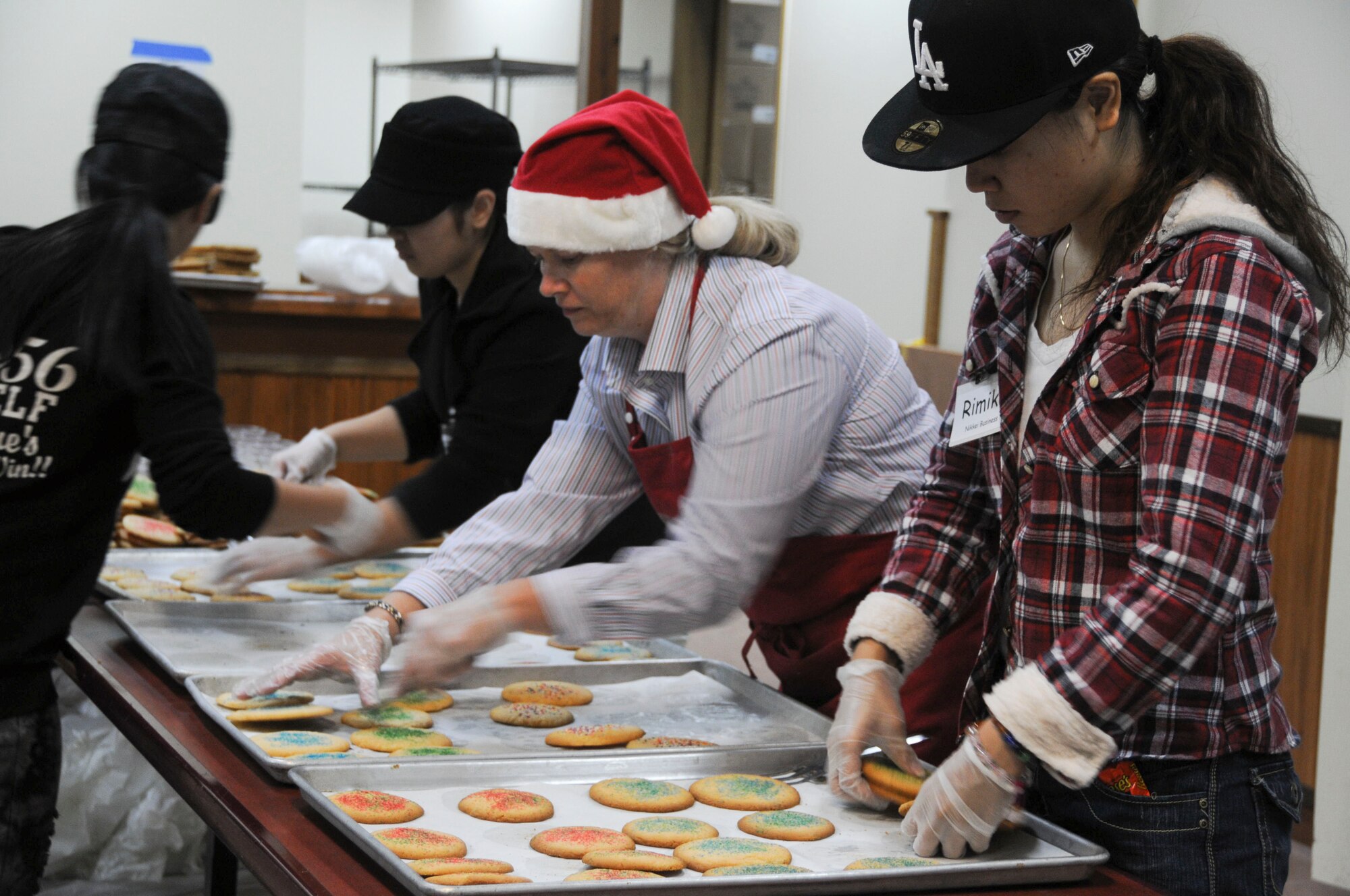 Ms. Charlotte Rupp, wife of 18th Wing Vice Commander Col. Ricky Rupp, and Ms. Rimiko Ashimine prepare cookies for packaging at Kadena Air Base Nov. 16. The local community assisted in making 2,500 packages of cookies that will be delivered to all military dorm residents. (U.S. Air Force photo/Staff Sgt. Darnell T. Cannady)
