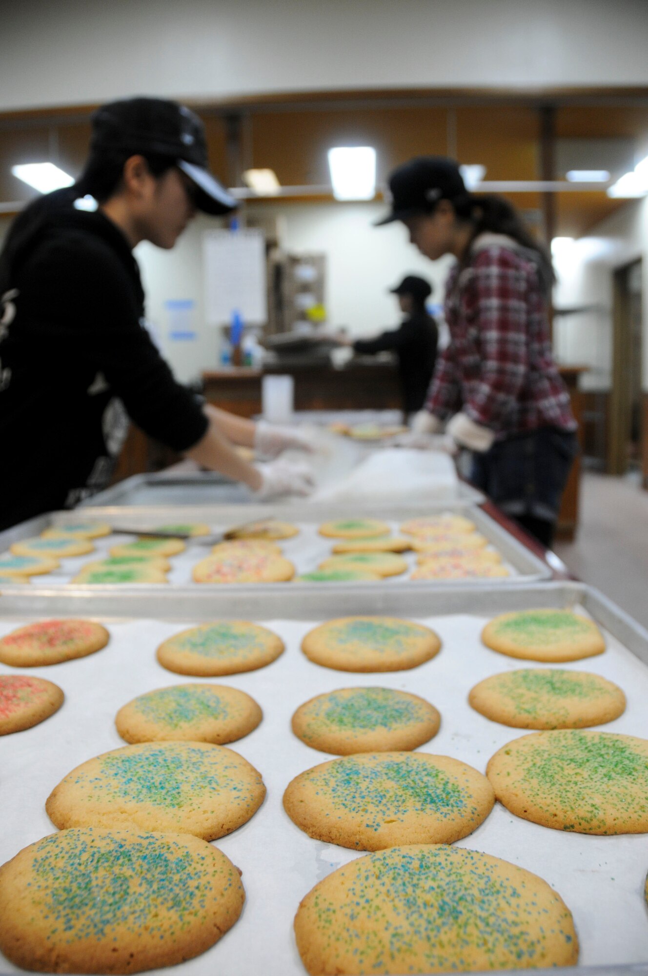 Ms. Marumi Furukawa and Ms. Rimiko Ashimine prepare cookies for packaging at Kadena Air Base Nov. 16. The local community assisted in making 2,500 packages of cookies that will be delivered to all military dorm residents. (U.S. Air Force photo/Staff Sgt. Darnell T. Cannady)