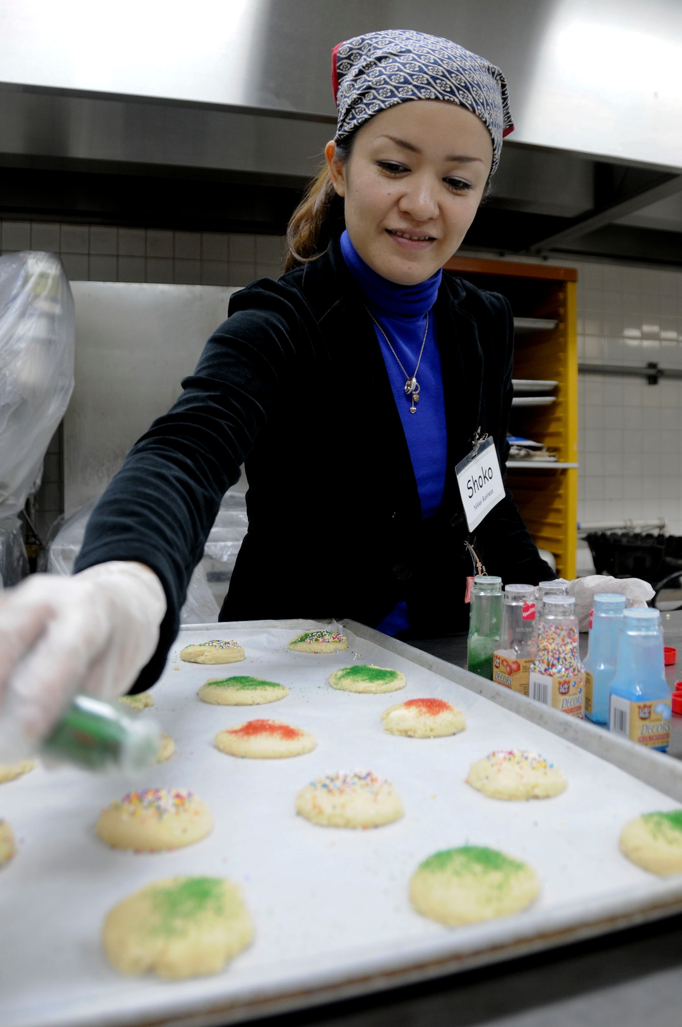 Ms. Shoko Yamamoto adds sprinkles to sugar cookies before they are placed in the oven at Kadena Air Base Nov. 16. The local community assisted in making 2,500 packages of cookies that will be delivered to all military dorm residents. (U.S. Air Force photo/Staff Sgt. Darnell T. Cannady)