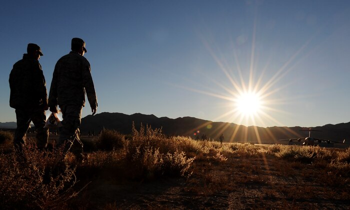 NELLIS AIR FORCE BASE, Nev. -- Airmen walk in between the Nellis runways to look for trash during a Foreign Object Debris walk Nov. 15. FOD prevention is every individual's responsibilities as it can cost millions of dollars of damage to aircraft systems and personnel. (U.S. Air Force photo by Senior Airman Brett Clashman)(Released)
