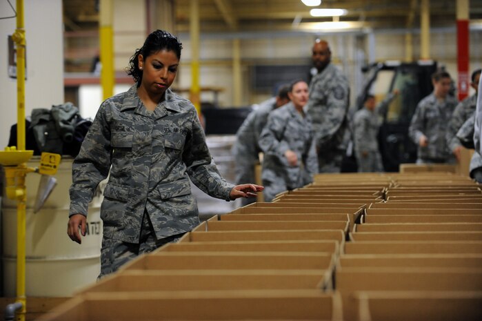 NELLIS AIR FORCE BASE, Nev. -- Senior Airman Bessy Ortiz, knowledge operation specialist with the 57th Adversary Tactics Group, counts the amount of boxes ready for packaging during Operation Warmheart, Nov. 12. Nellis Airmen volunteered Friday morning to help create packages, and fill them with Thanksgiving meal items, so they can be delivered to homes and work centers. (U.S. Air Force photo by Senior Airman Brett Clashman)(Released)
