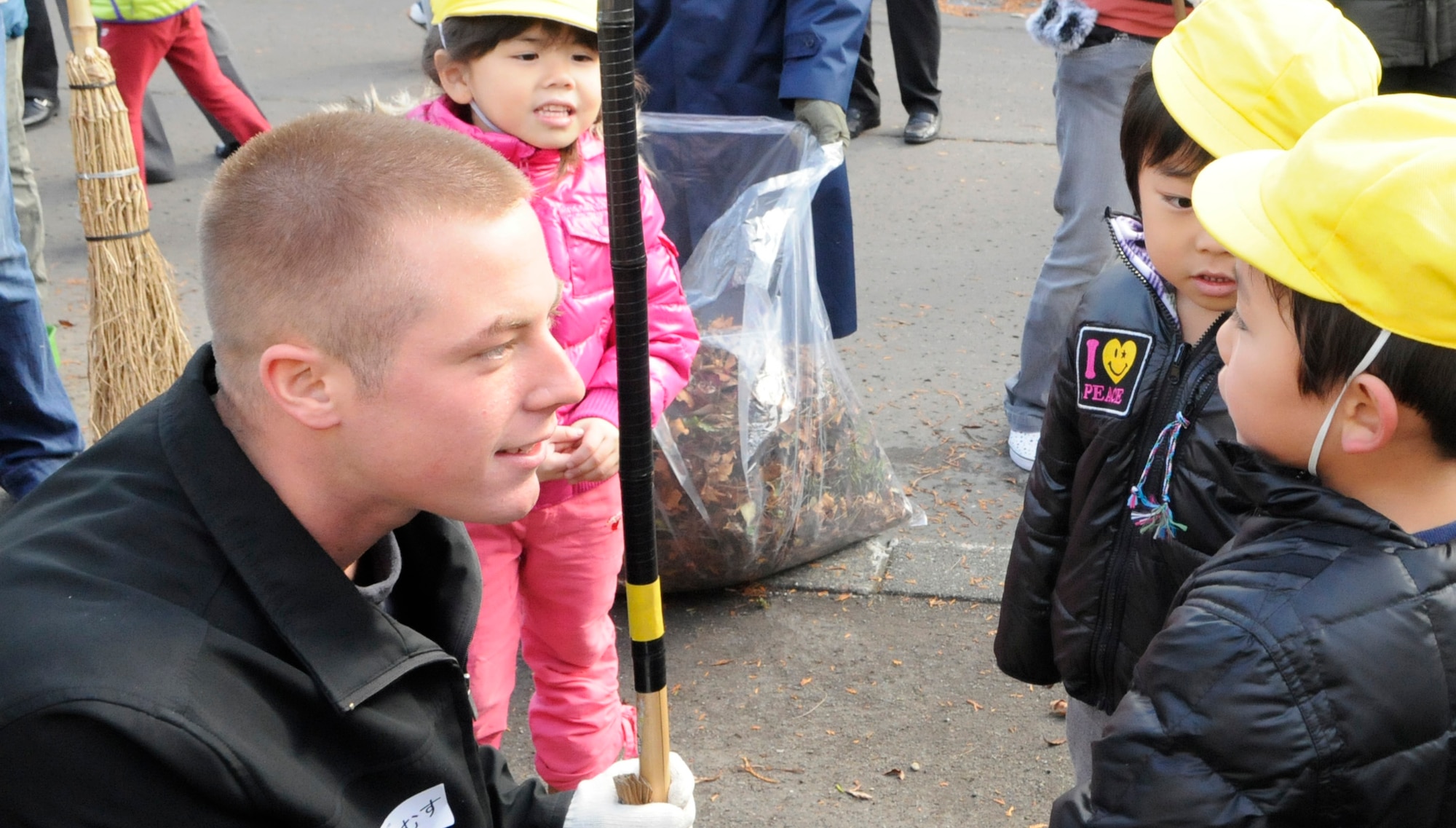 Airman 1st Class James Bissen, 18th AMXS, talks with a student from the Hokuto preschool in Chitose, Japan, Nov. 15, 2010.   A dozen Airmen based out of Kadena Air Base paid a visit to the school during their temporary duty. Nearly 200 Airmen are at Chitose Air Base, Japan as part of an Aviation Training Location designed to enhance bilateral relations between Japan and the U.S. (U.S. Air Force photo by Tech. Sgt. Mike Tateishi)
