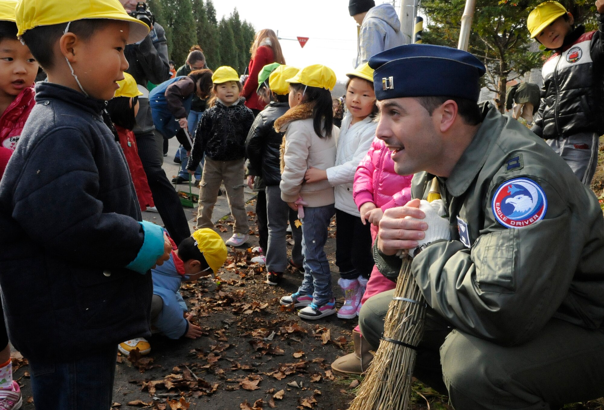 Capt. Tyler Marsh, 44th Fighter Squadron talks with a student from the Hokuto preschool in Chitose, Japan, Nov. 15, 2010.   A dozen Airmen based out of Kadena Air Base paid a visit to the school during their temporary duty. Nearly 200 Airmen are at Chitose Air Base, Japan as part of an Aviation Training Location designed to enhance bilateral relations between Japan and the U.S. (U.S. Air Force photo by Tech. Sgt. Mike Tateishi)