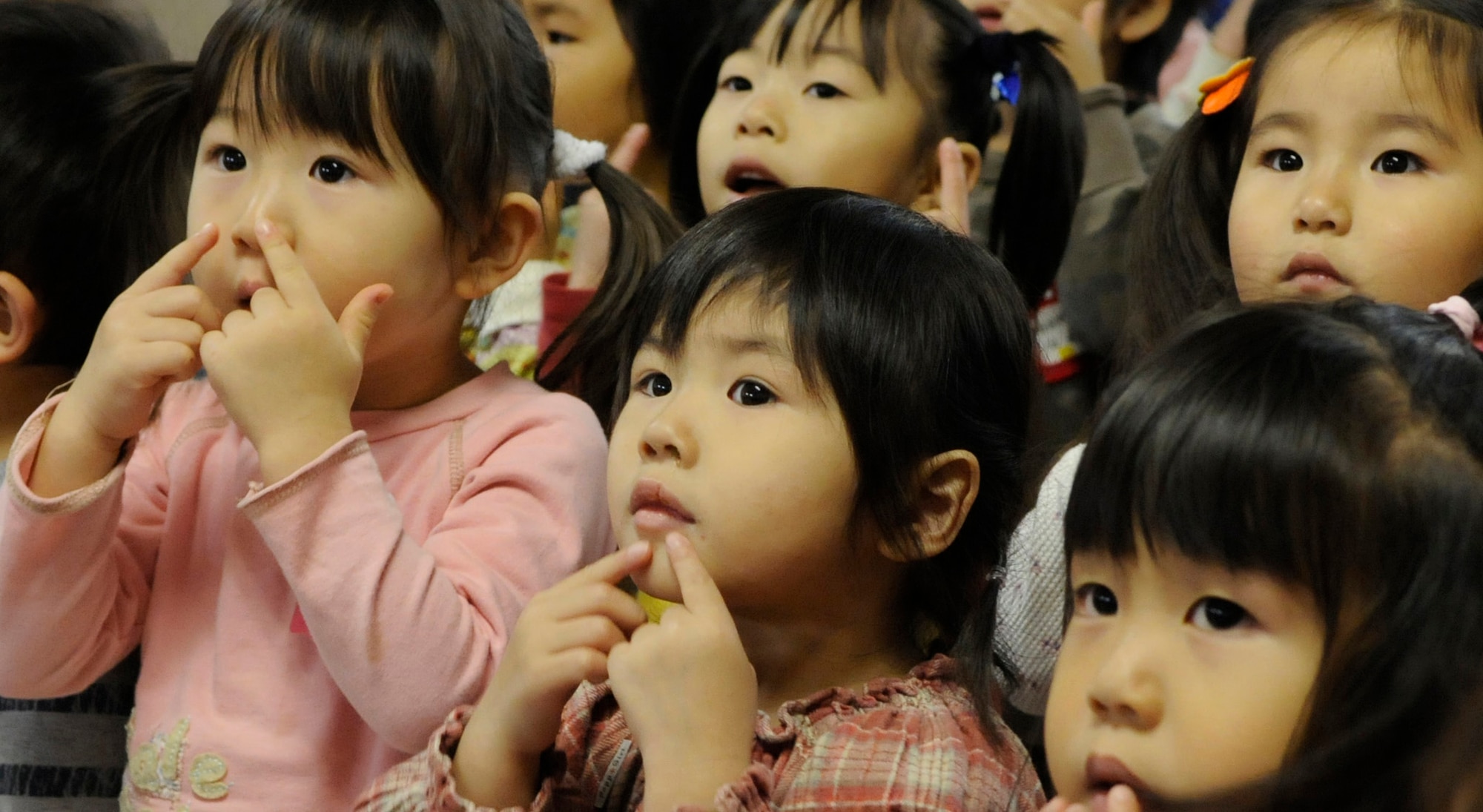A group of girls from the Hokuto Preschool act out, “Head, shoulders, knees and toes” in Chitose, Japan, Nov. 15, 2010. A dozen Airmen based out of Kadena Air Base paid a visit to the school during their temporary duty. Nearly 200 Airmen are at Chitose Air Base, Japan as part of an Aviation Training Location designed to enhance bilateral relations between Japan and the U.S. (U.S. Air Force photo by Tech. Sgt. Mike Tateishi)