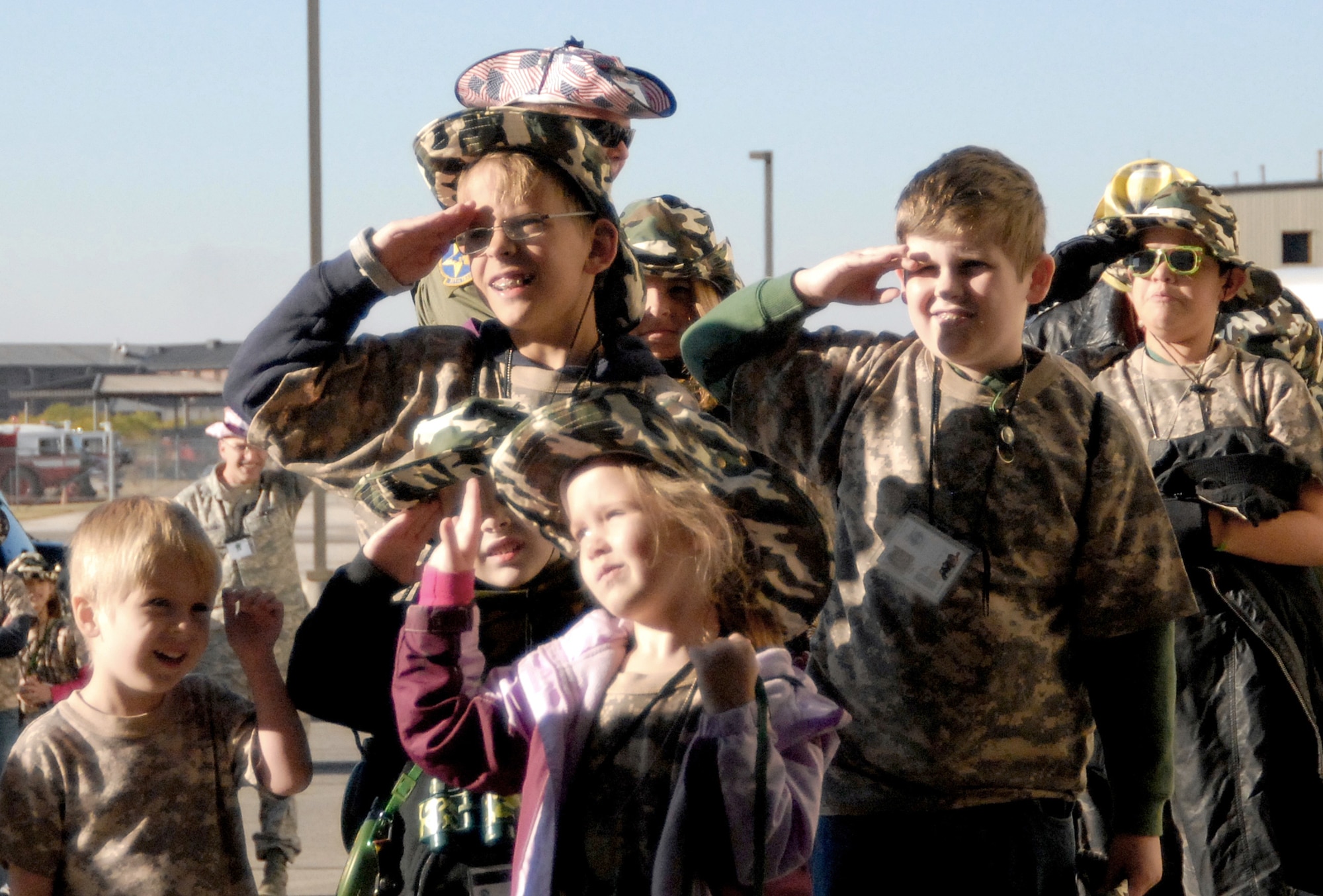 Before entering the deployed air base, youths with Operation KIDS learn how to salute when encountering an officer Nov. 13, 2010, at Goodfellow Air Force Base, Texas. At the "deployed air base" the youths completed a Marine Corps obstacle course, went through a confined space tunnel and were instructed on proper use of various fire rescue vehicles. (U.S. Air Force photo/Connie Hempel)
