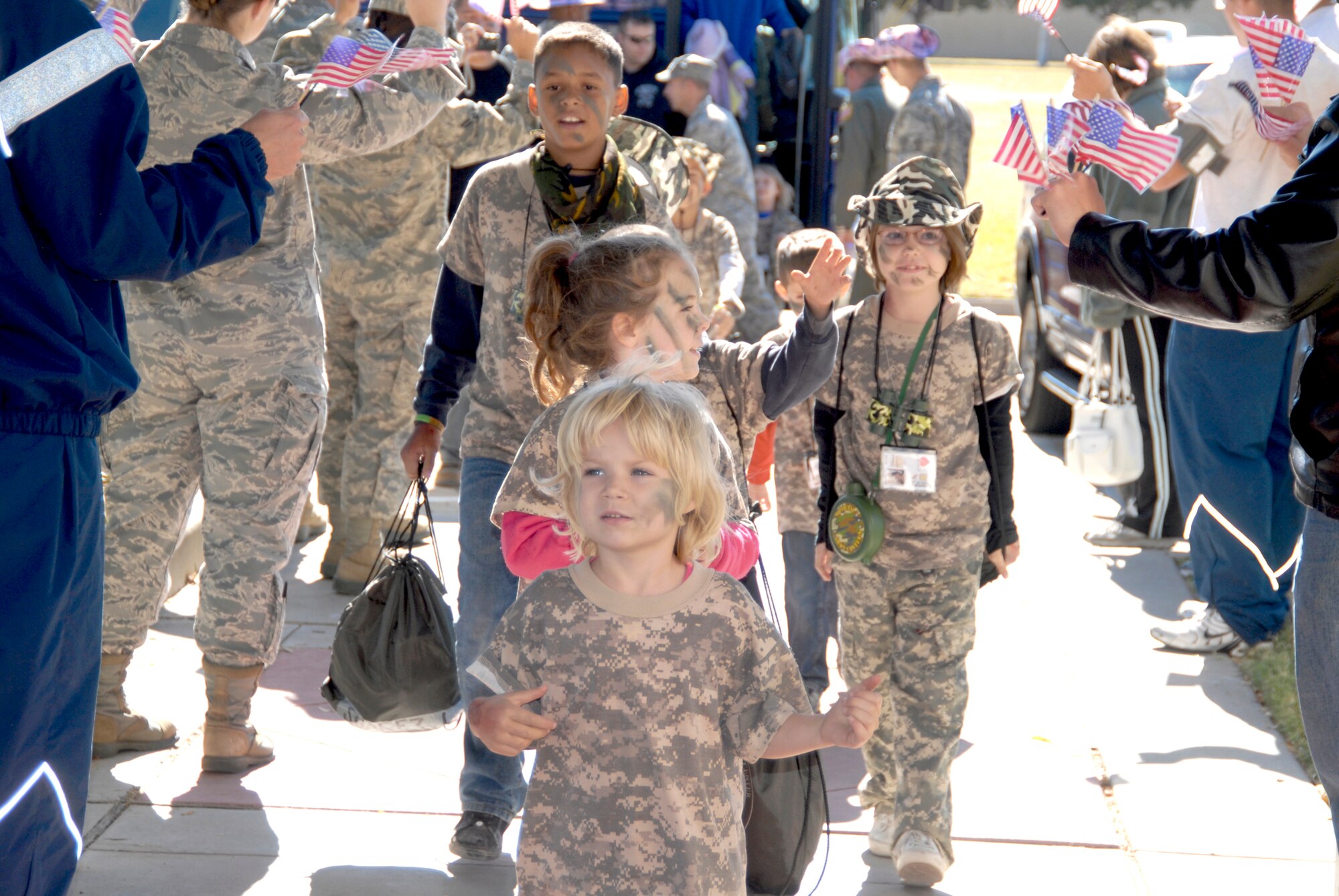 Georgia Shirley, 5, leads her squad to the welcome home celebration at the event center for the Operation KIDS 2010 participants Nov. 13, 2010at Goodfellow Air Force Base, Texas. More than 60 military youths participated in this year's event to get a glimpse of what their military parents go through when deploying. (U.S. Air Force photo/Connie Hempel)
