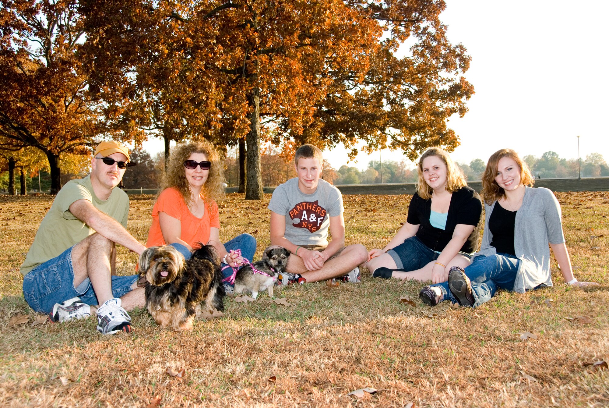 Senior Master Sgt. Duane Moore, 189th Operations Support Flight, and his family received the Air National Guard Family of the Year Award in August at the National Volunteer Workshop. (Left to right) Sergeant Moore with Sarge their Yorkie; Lisa, his wife, with rescue dog, Sadie; and their children Kyle, Eden and Dara at the Little Rock Air Force Base lake. (U.S. Air Force photo by Master Sgt. Dianna Seerey)