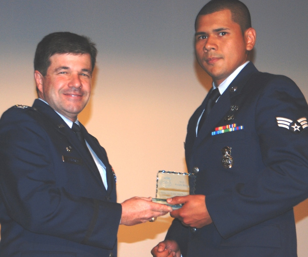 Senior Airman Daniel Sanchez, receives  the  Airman of the 4th Quarter Award from Col. William Edwards, commander of the 932nd Airlift Wing. Sanchez is a member of the 932nd Civil Engineer Squadron.  The Wing's  quarterly award winners were announced at commander's call. (U.S. Air Force photo/Tech. Sgt. Dan Oliver)   